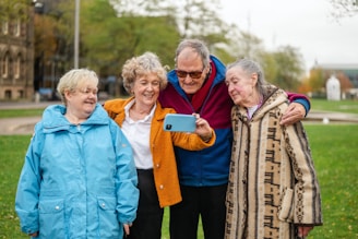 Four seniors taking a selfie outdoors