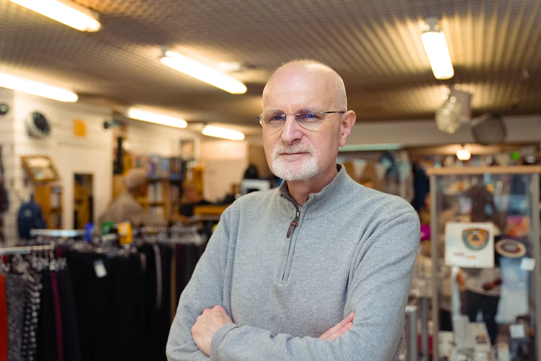 An older man with glasses in a shop, representing a resident whose finances and independence deserve protection