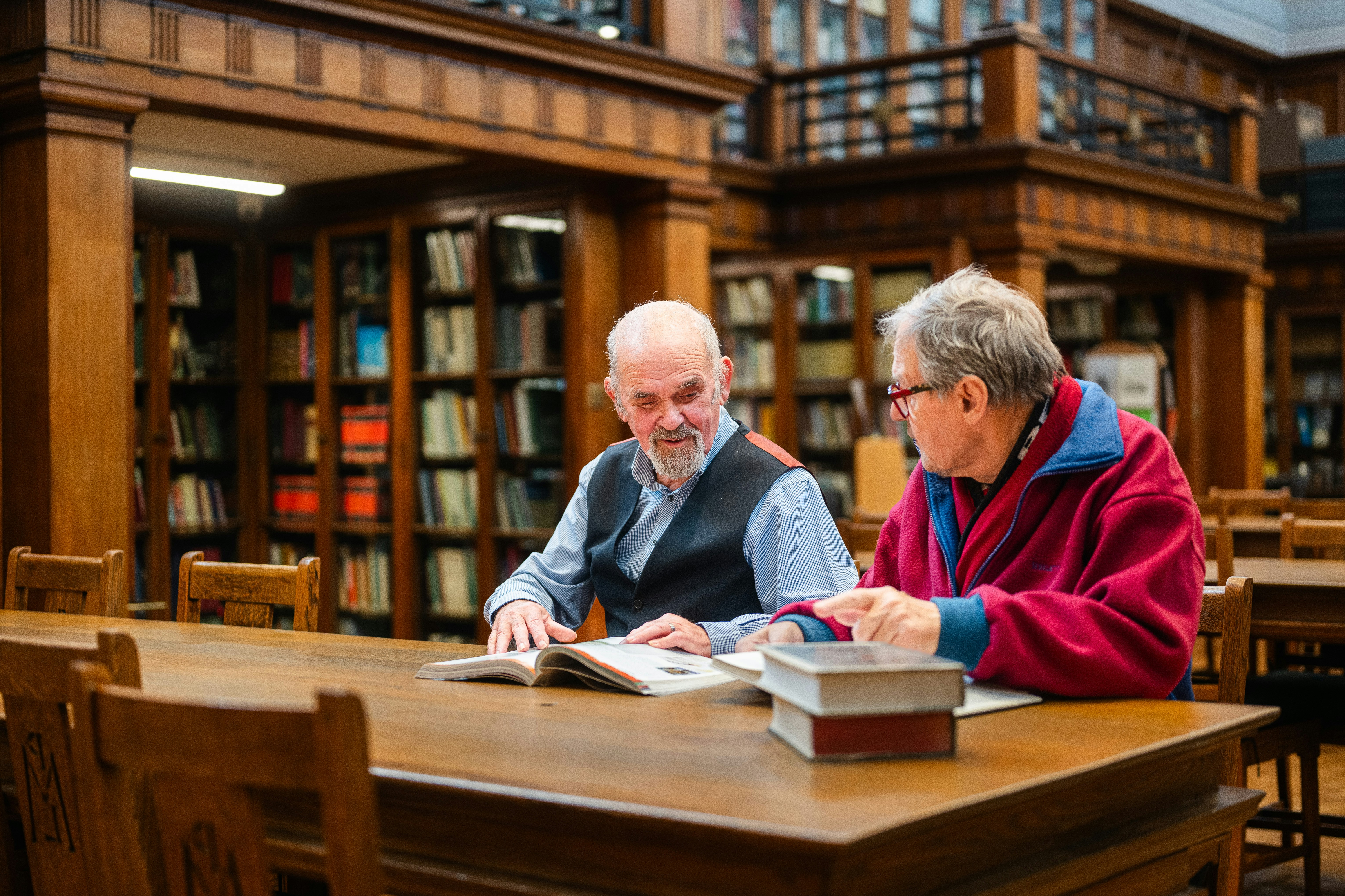 Two men studying books
