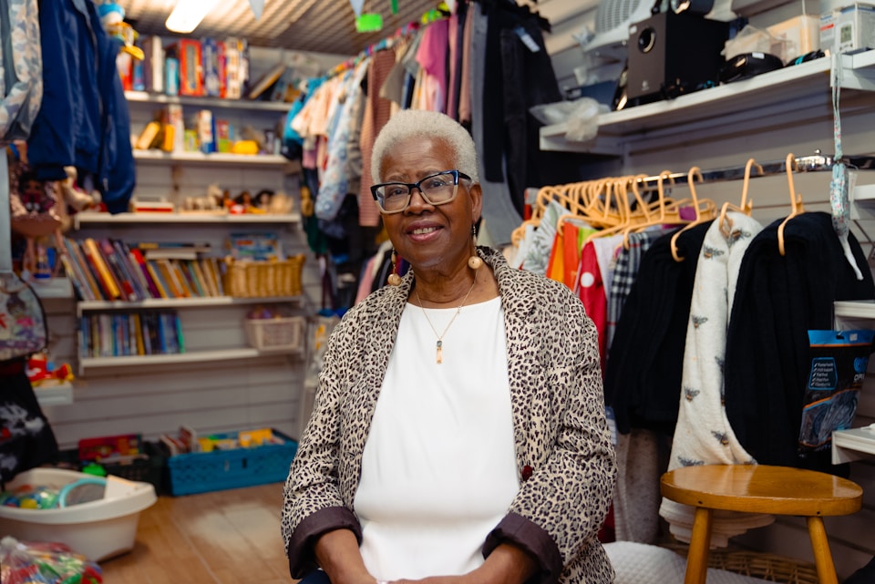 A female business owner smiling in her store