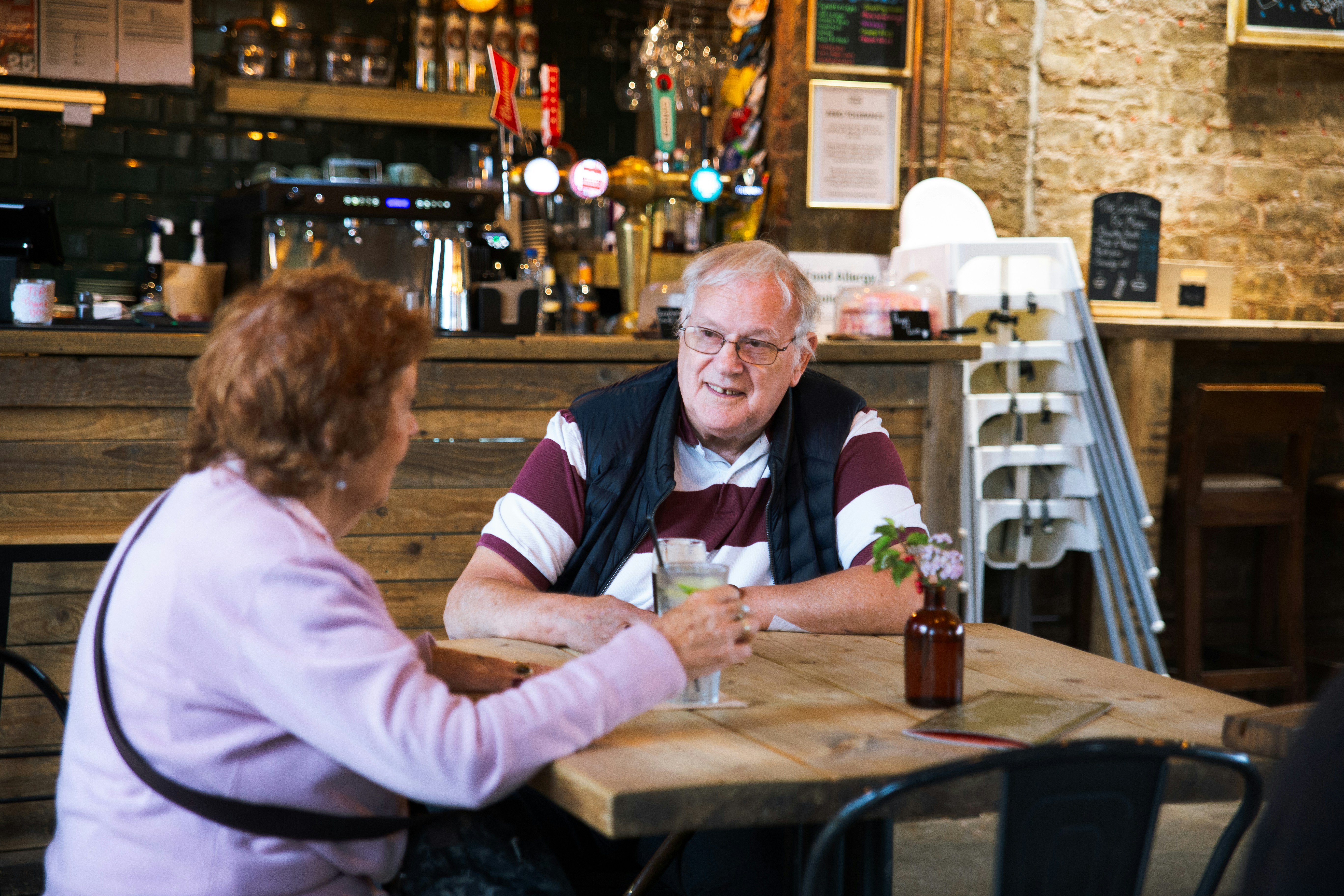 Couple talking at a table in a pub