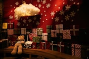 Teddy bear with christmas gifts and snowflakes