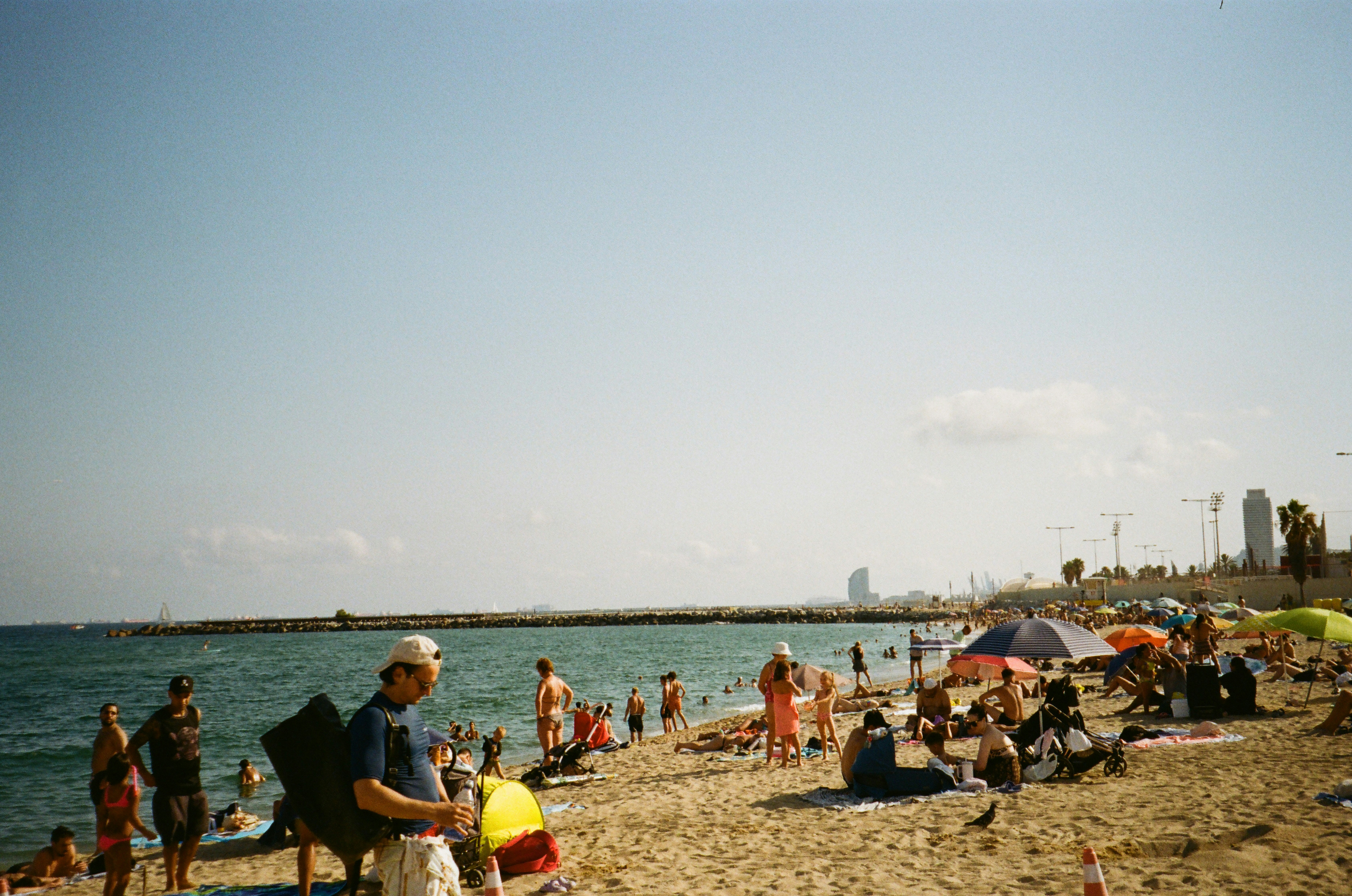 People relaxing on a sunny beach with ocean views