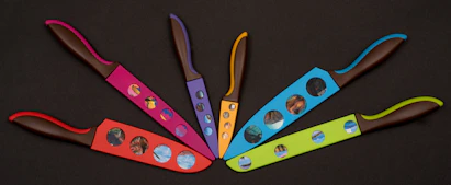 Set of colorful knives arranged in a fan shape