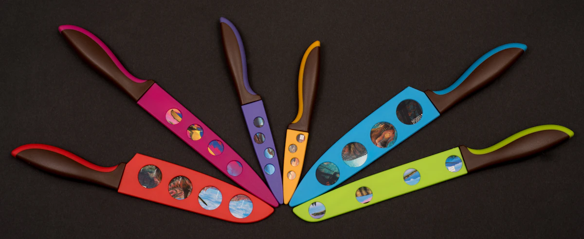 Set of colorful kitchen knives arranged in a fan shape