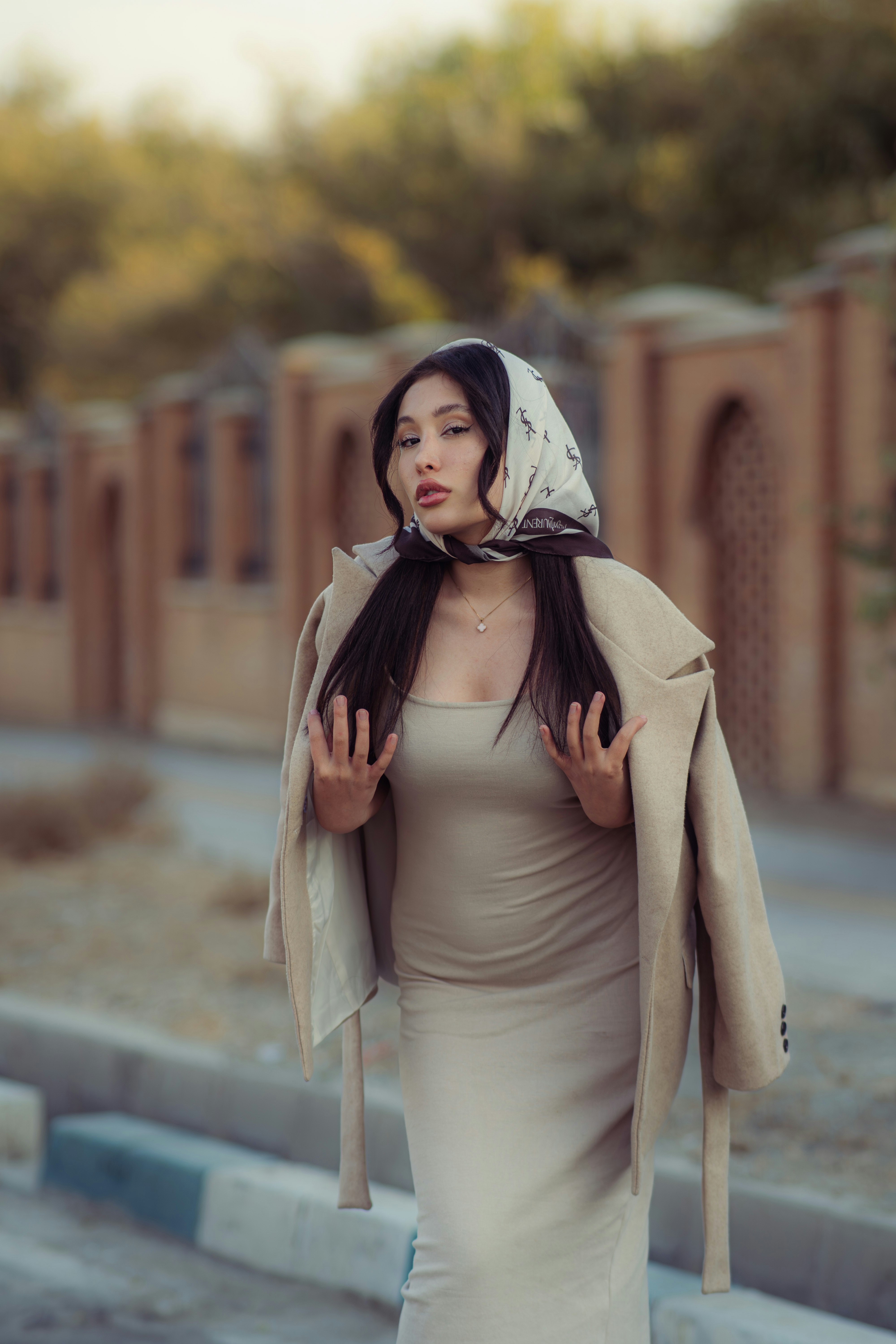 Woman wearing a headscarf and coat outdoors