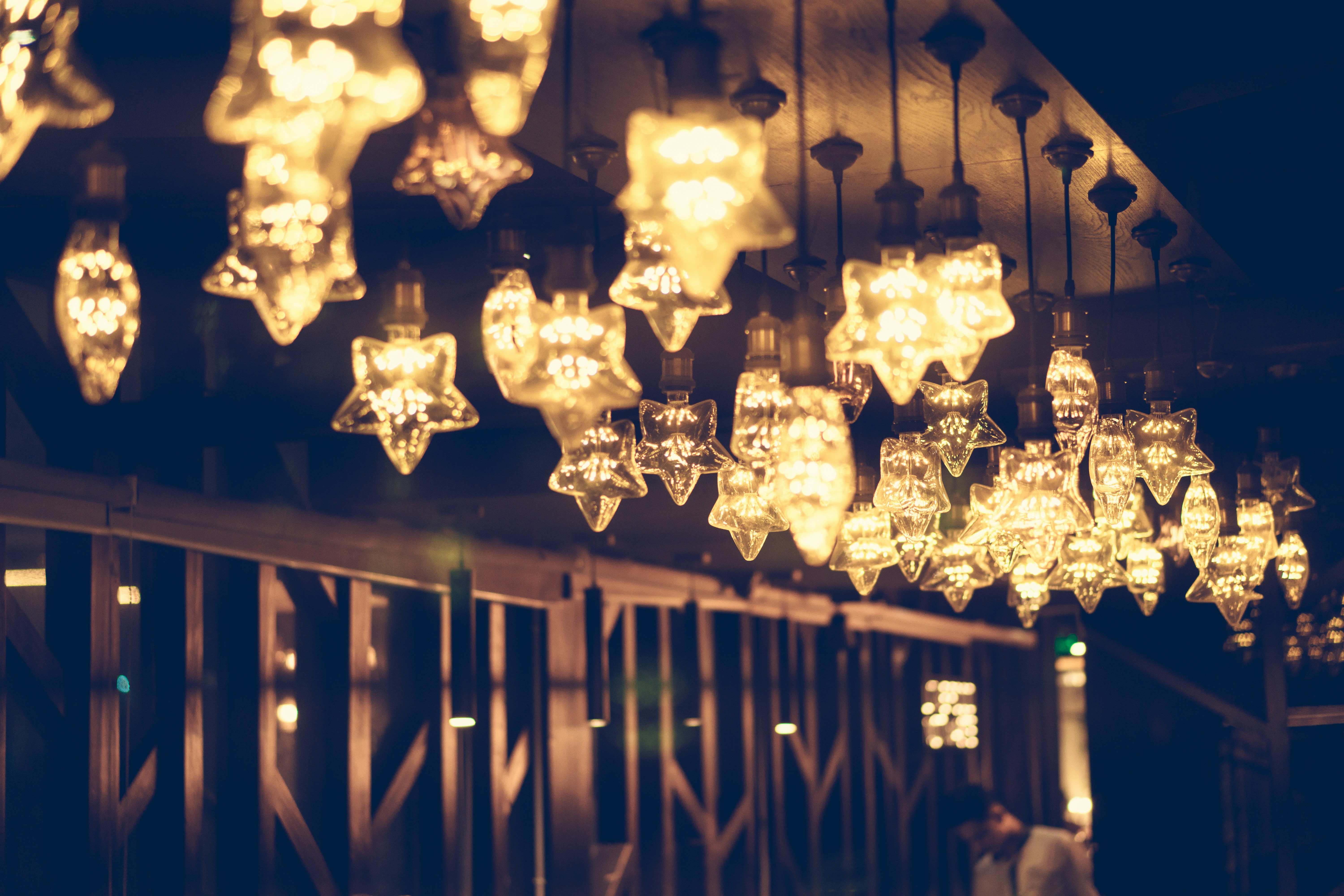 Many star-shaped lights hanging from ceiling