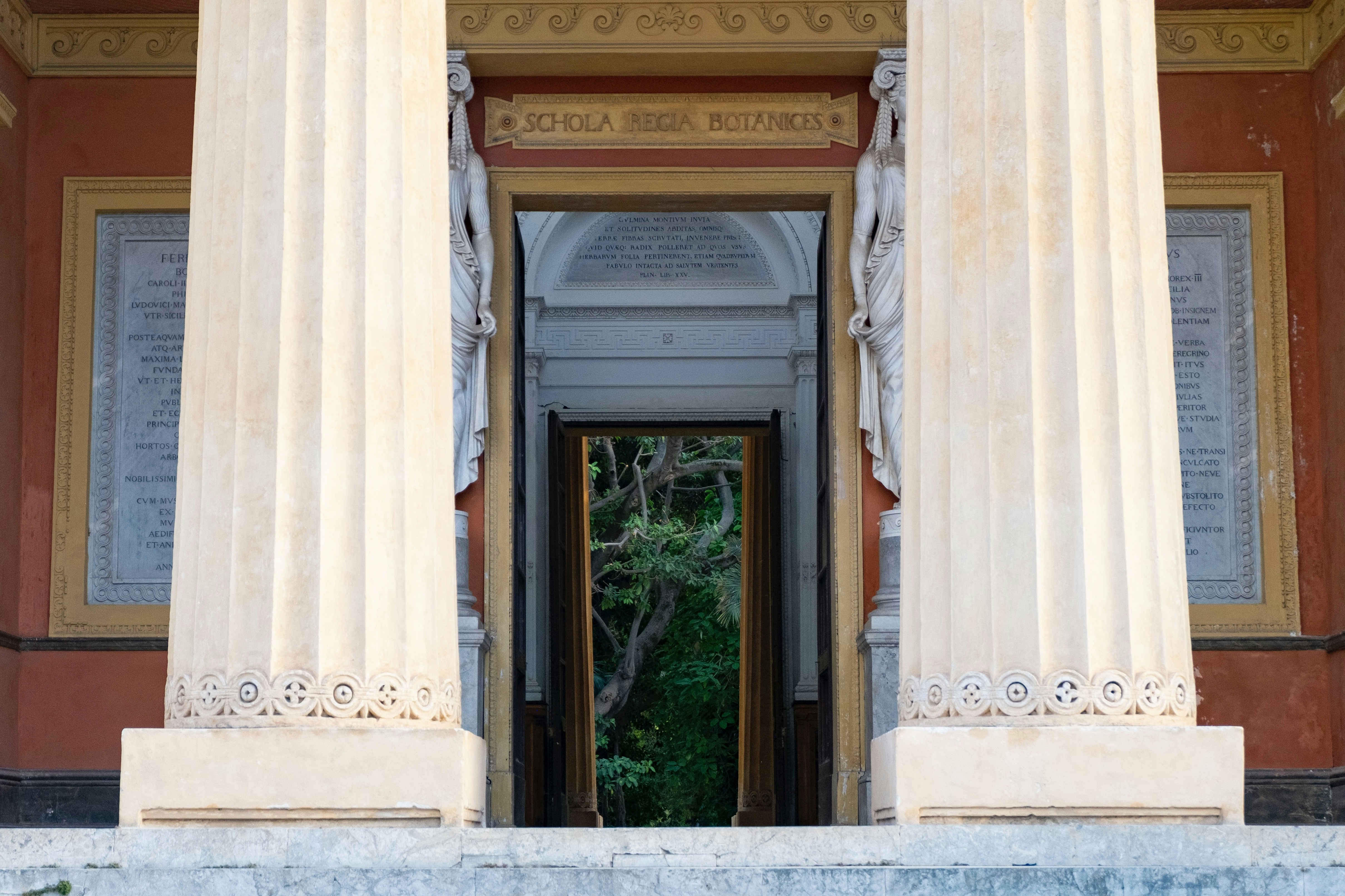 Grand entrance with large columns and open doorway