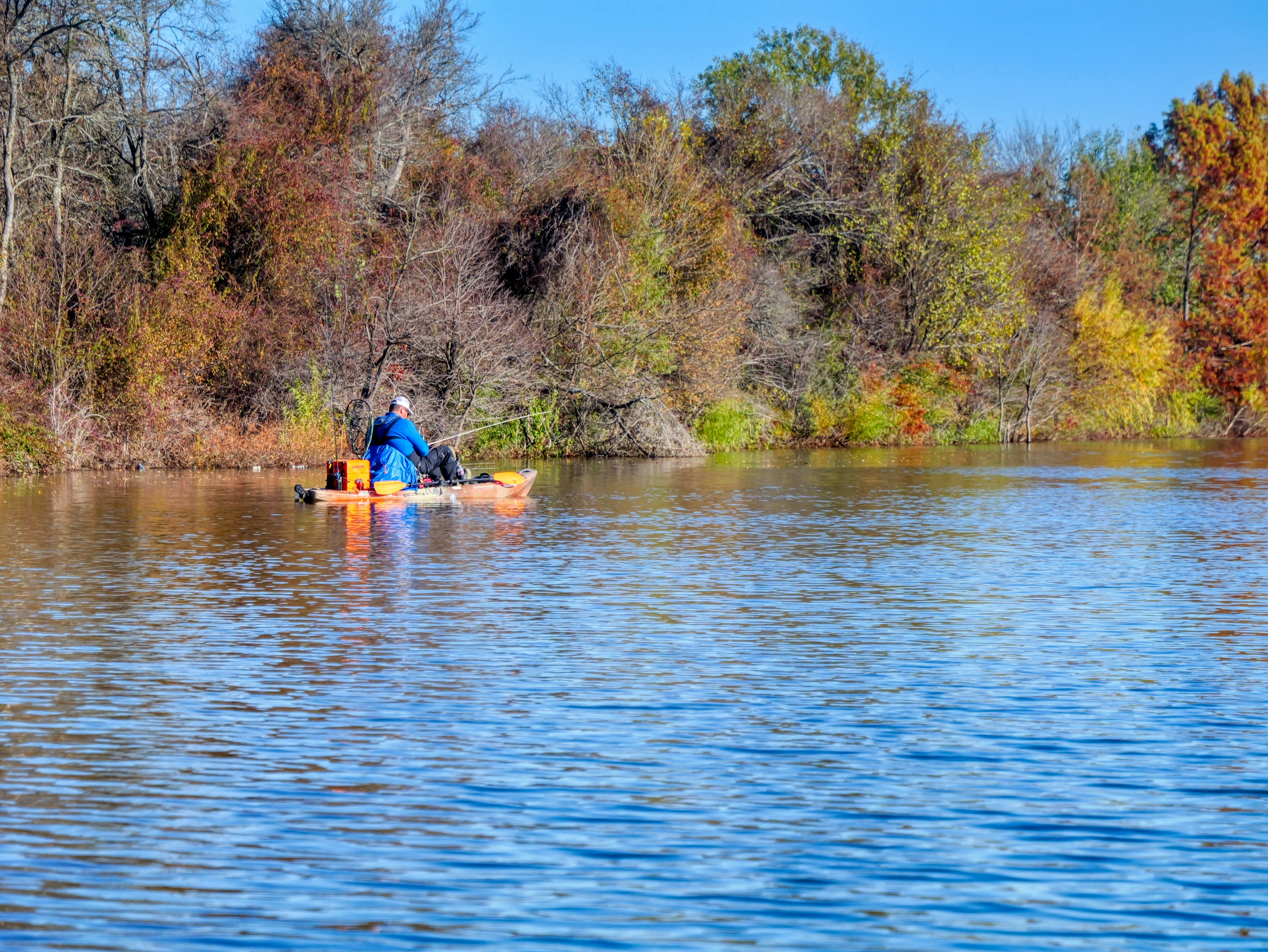 Man fishing from a kayak on a lake