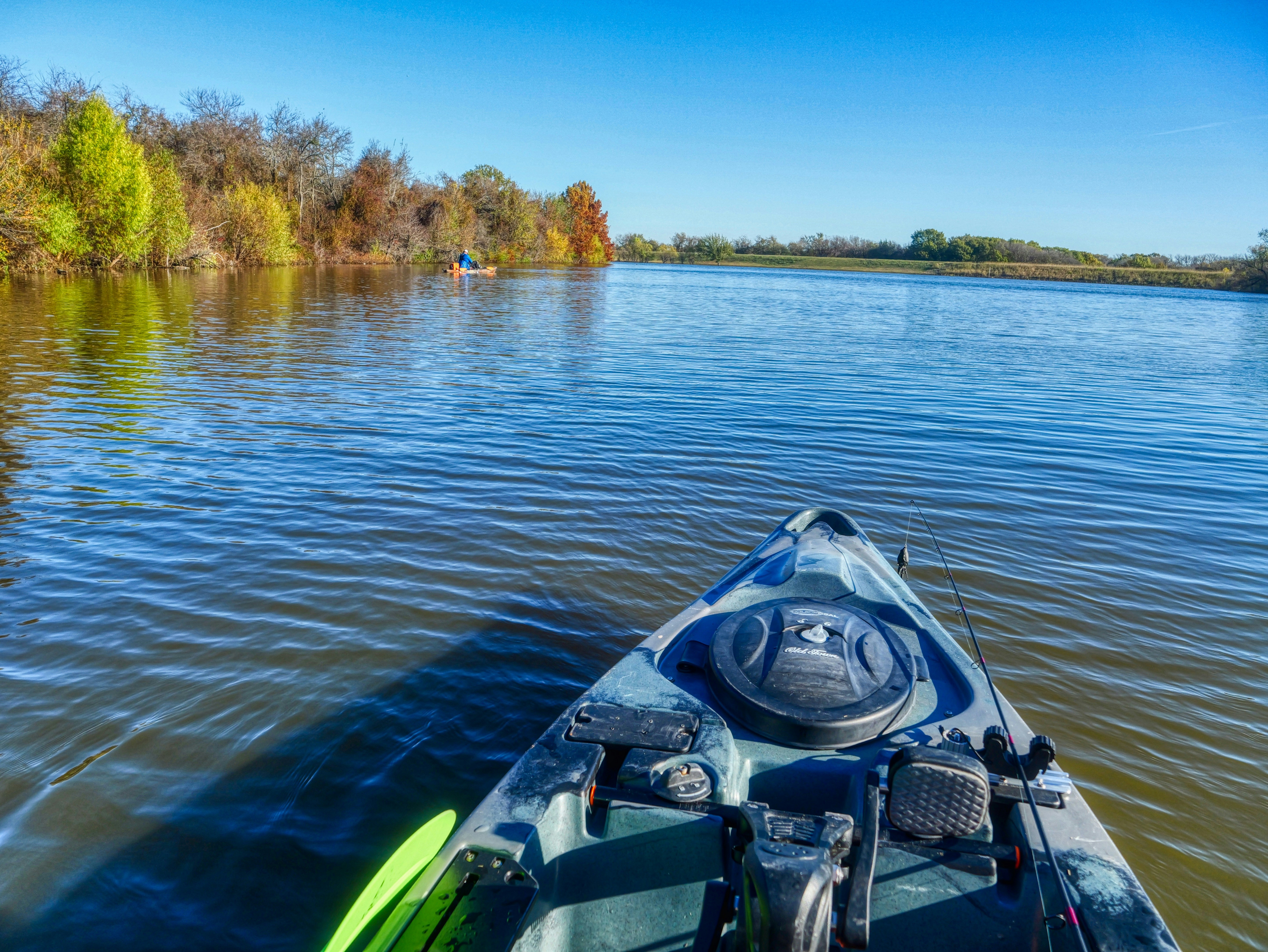Kayaking on a calm lake with autumn trees