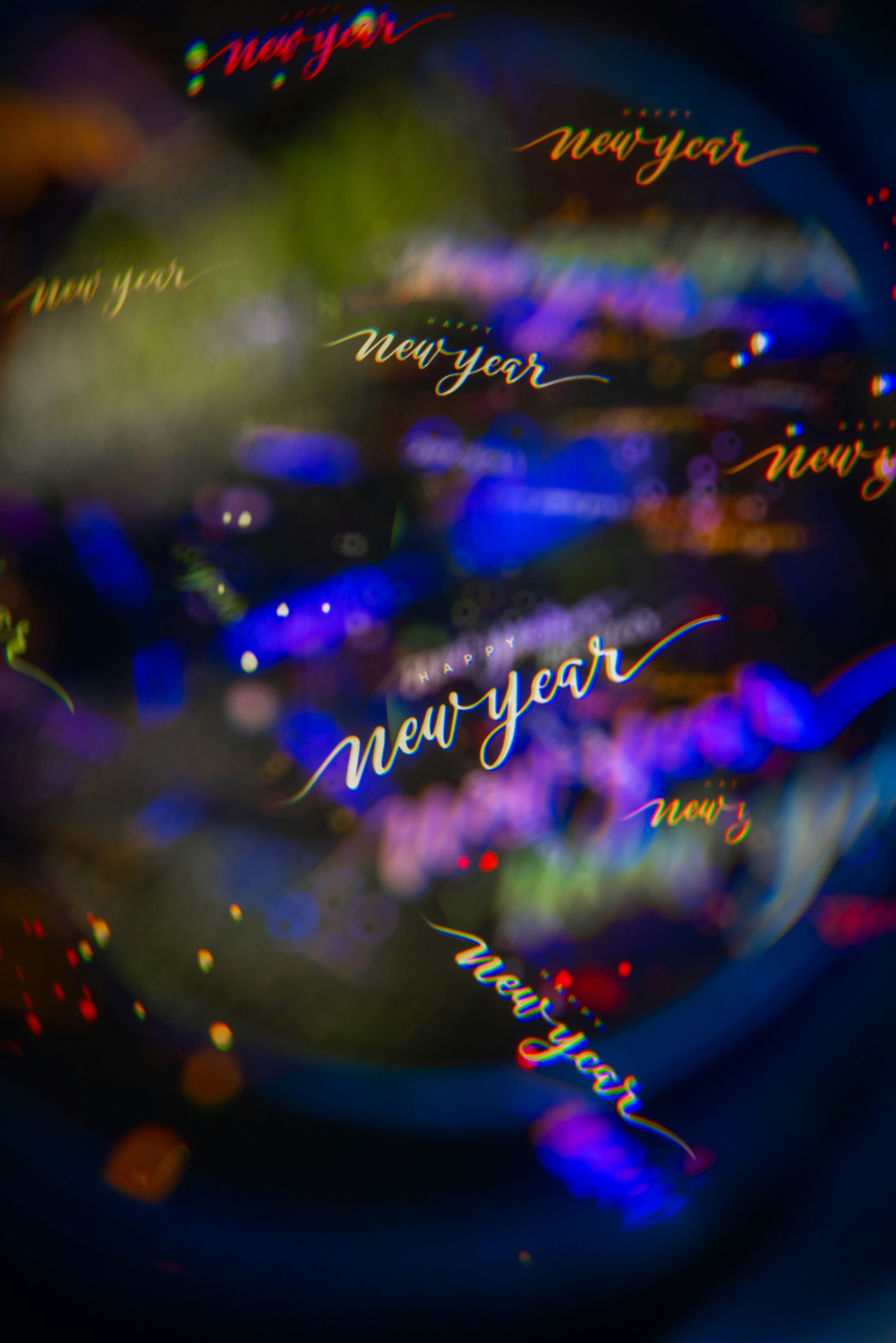 New year text with bokeh lights background