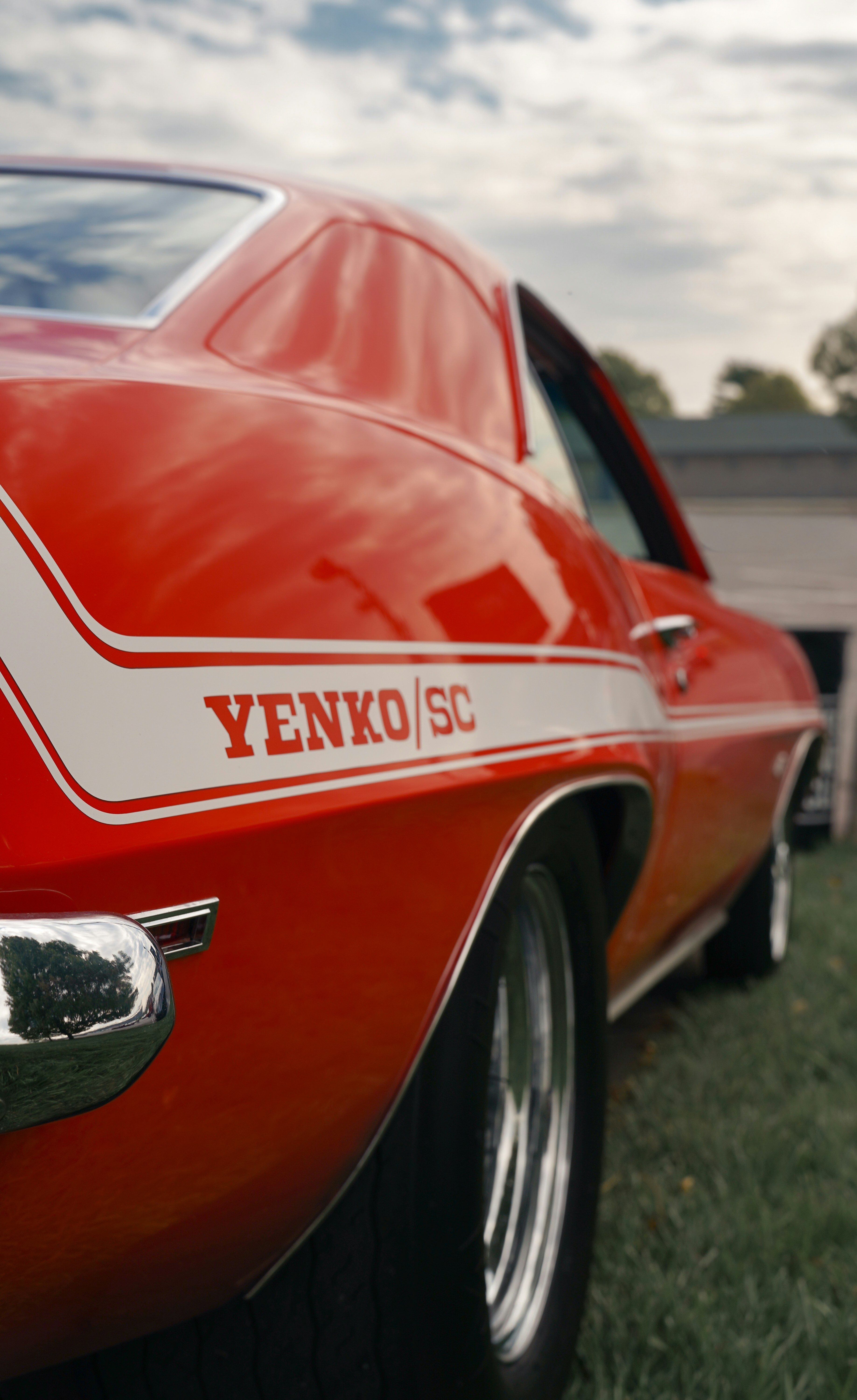 Red yenko/sc classic car parked on grass
