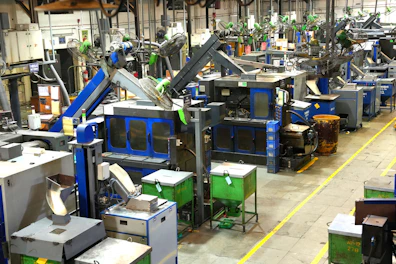 Industrial factory floor with machinery and yellow lines.