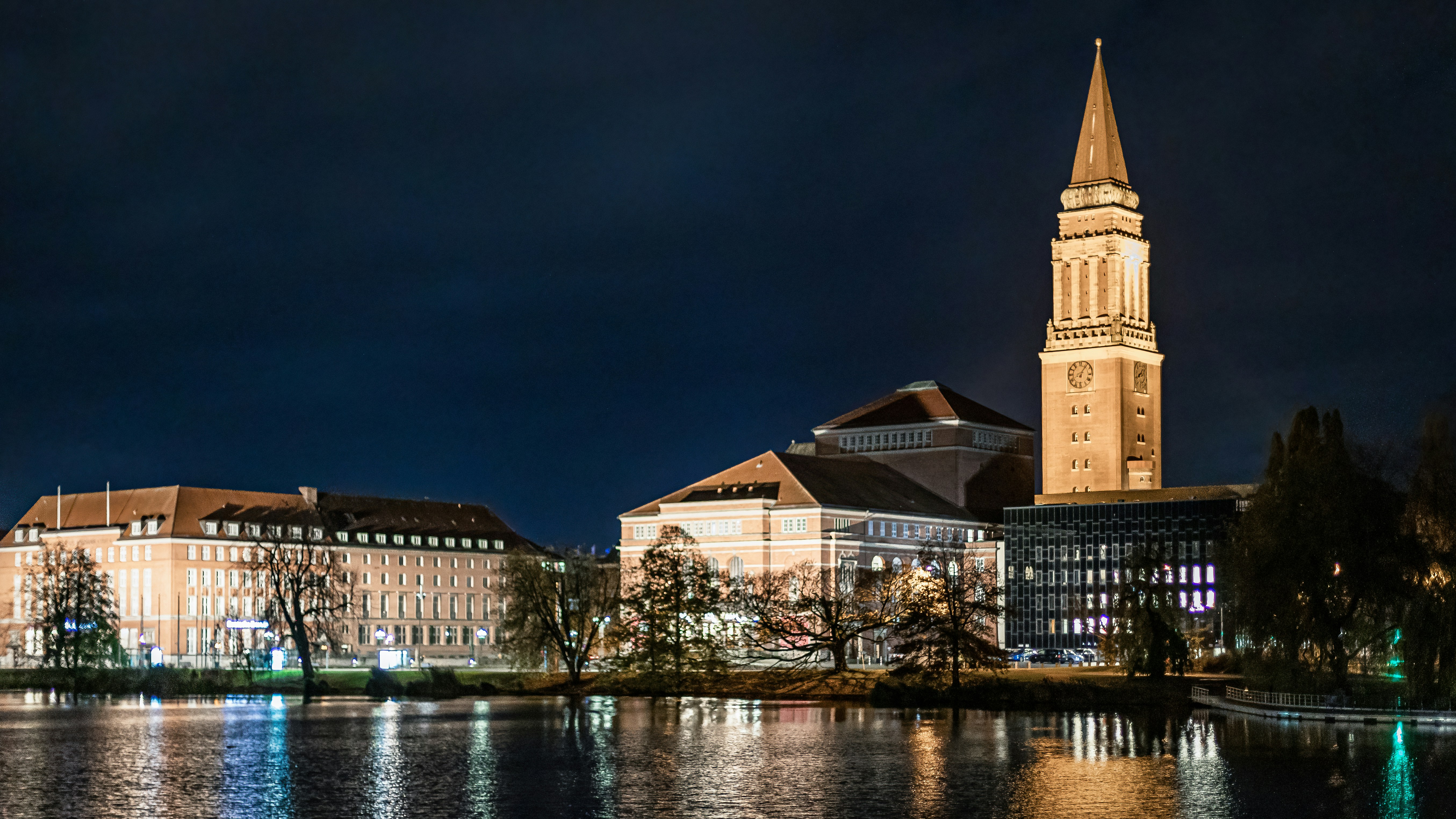City buildings reflected in water at night