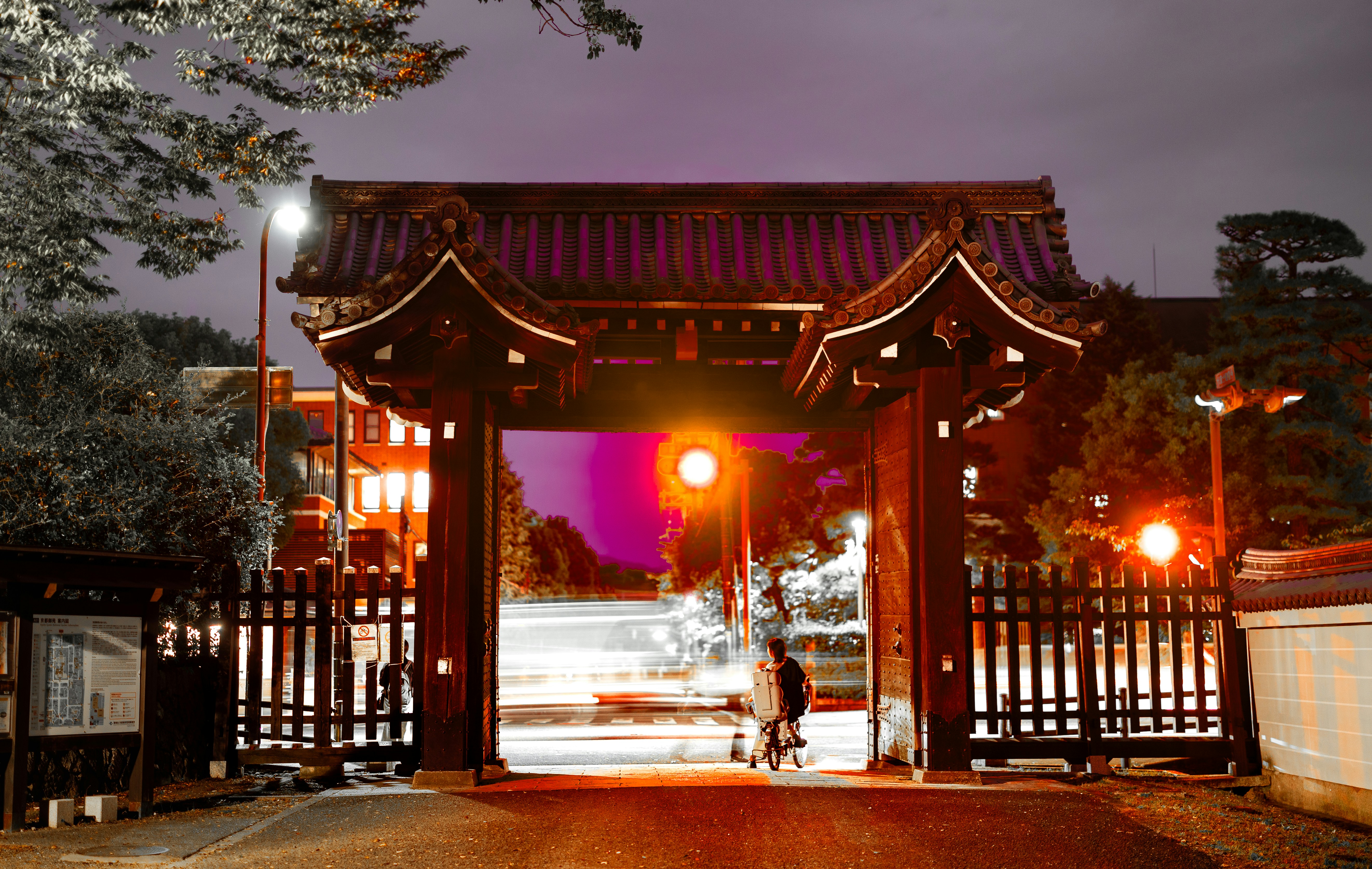 Traditional japanese gate at night with blurred lights.