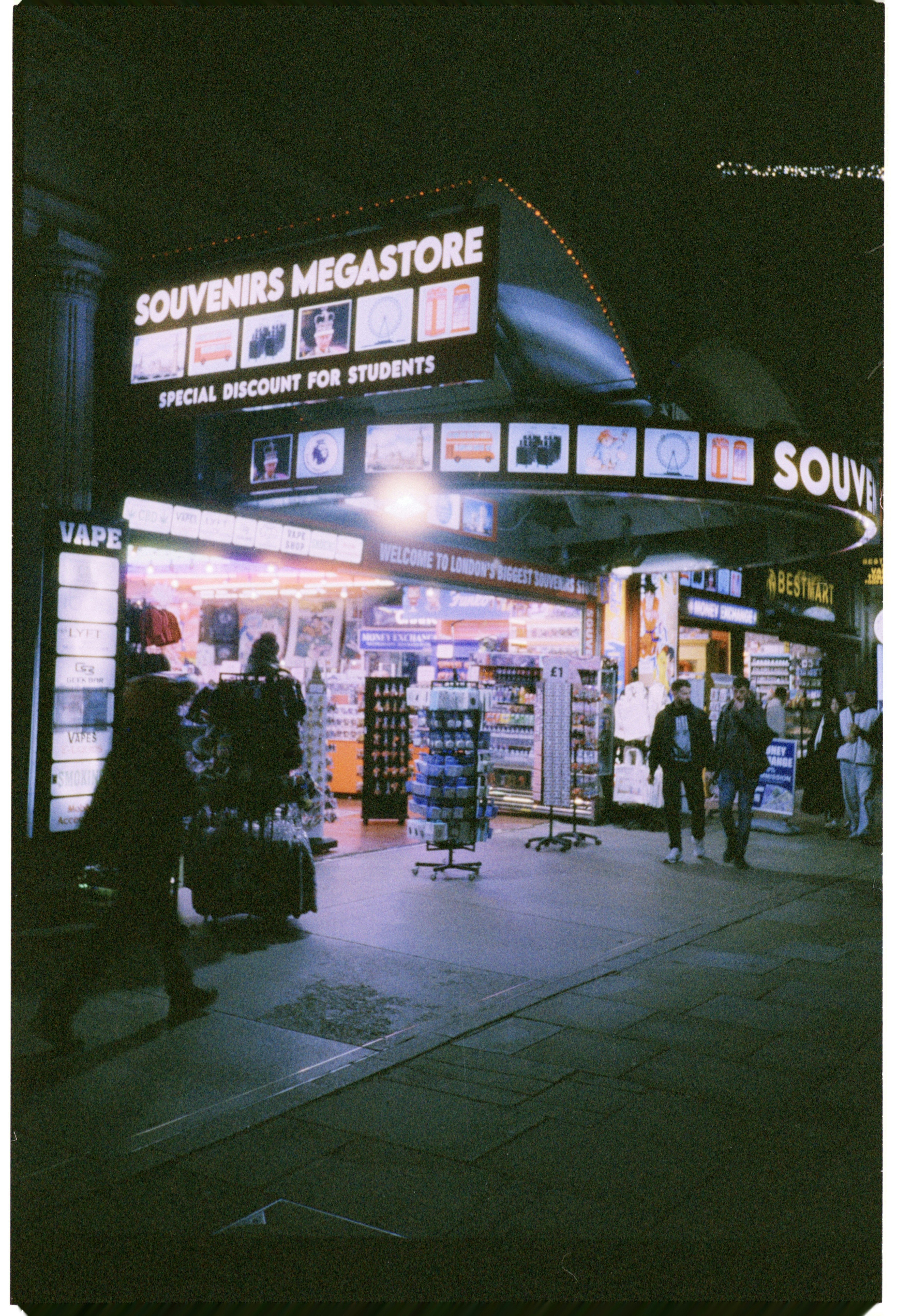 Souvenirs megastore illuminated at night with shoppers