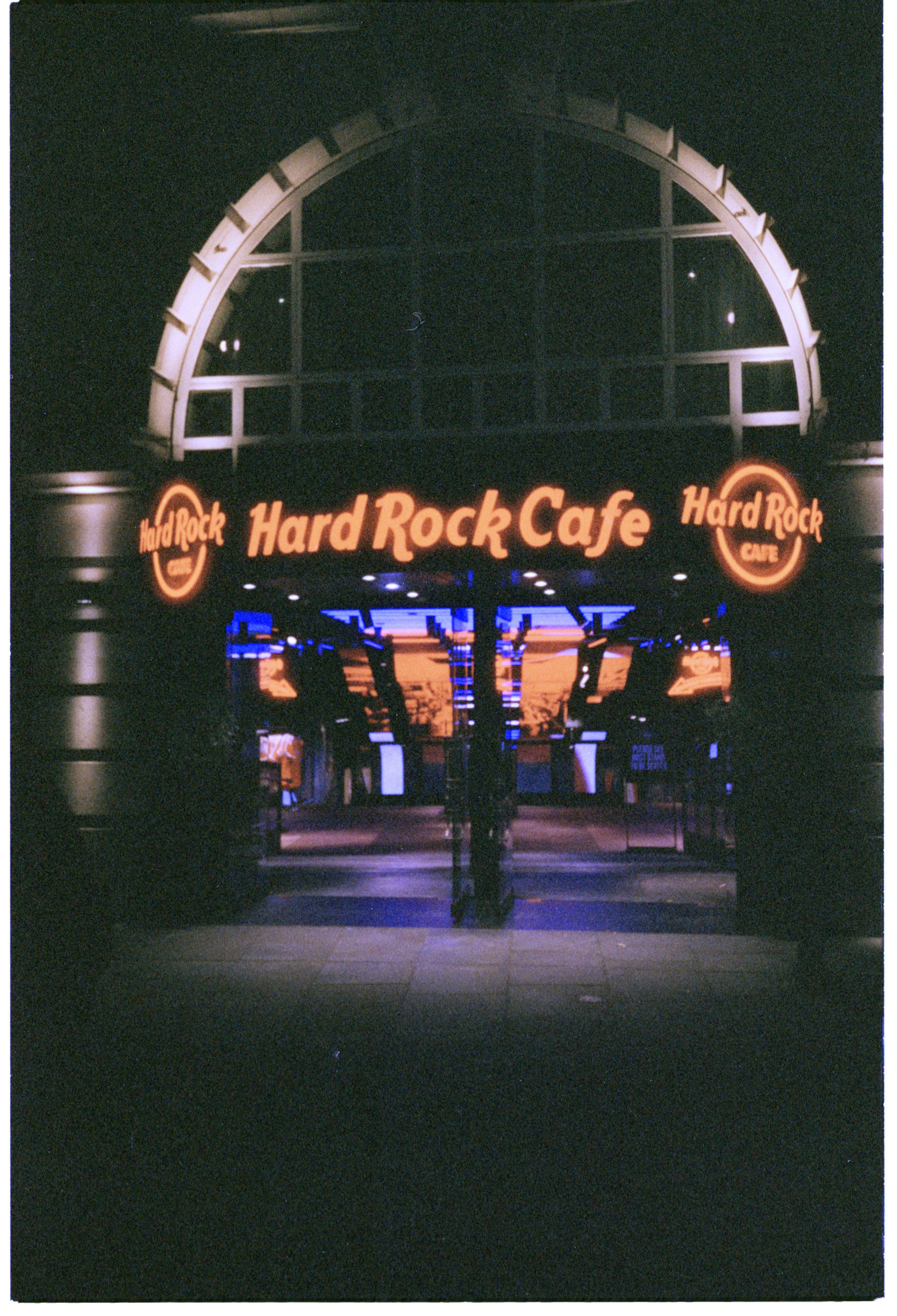 Hard rock cafe entrance at night with neon signs