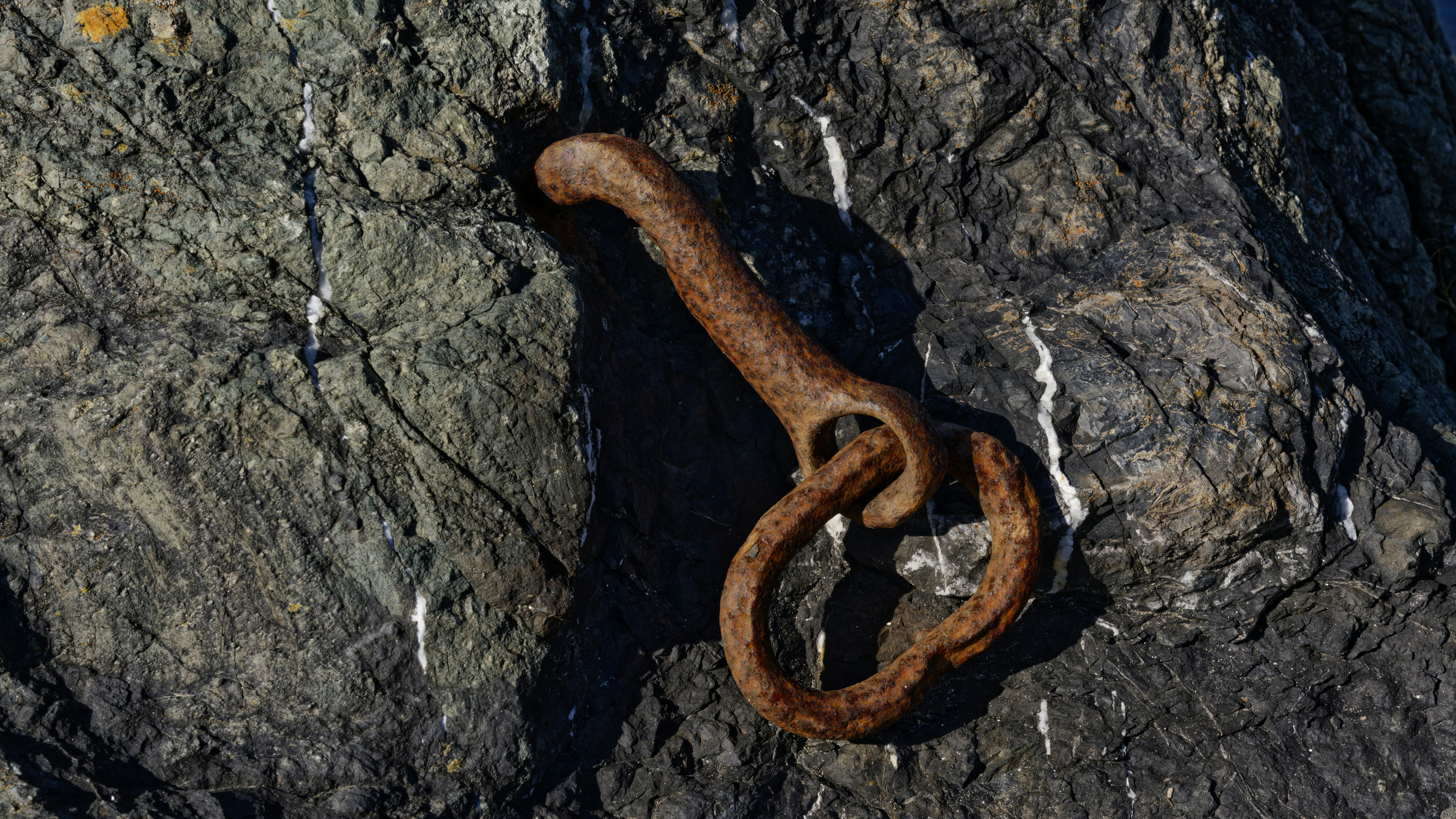 Rusty metal ring embedded in rock