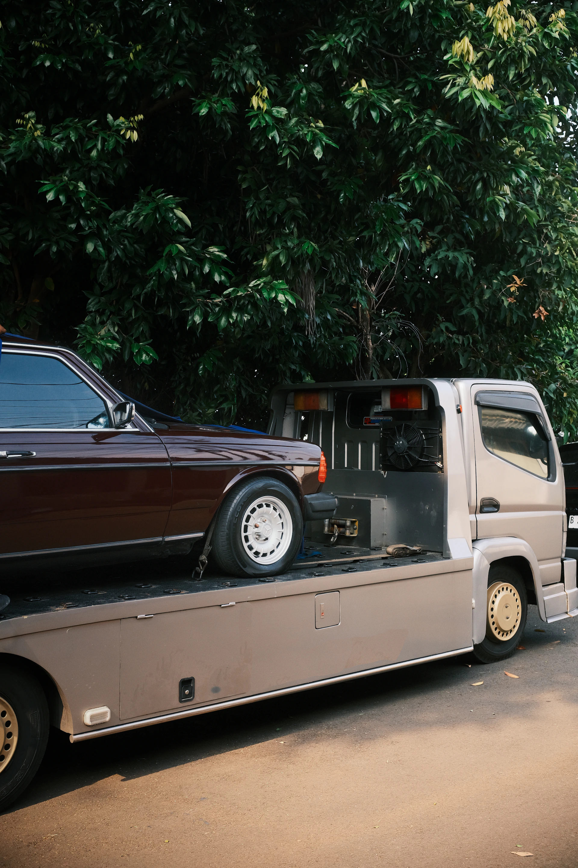 A car being towed on a flatbed truck