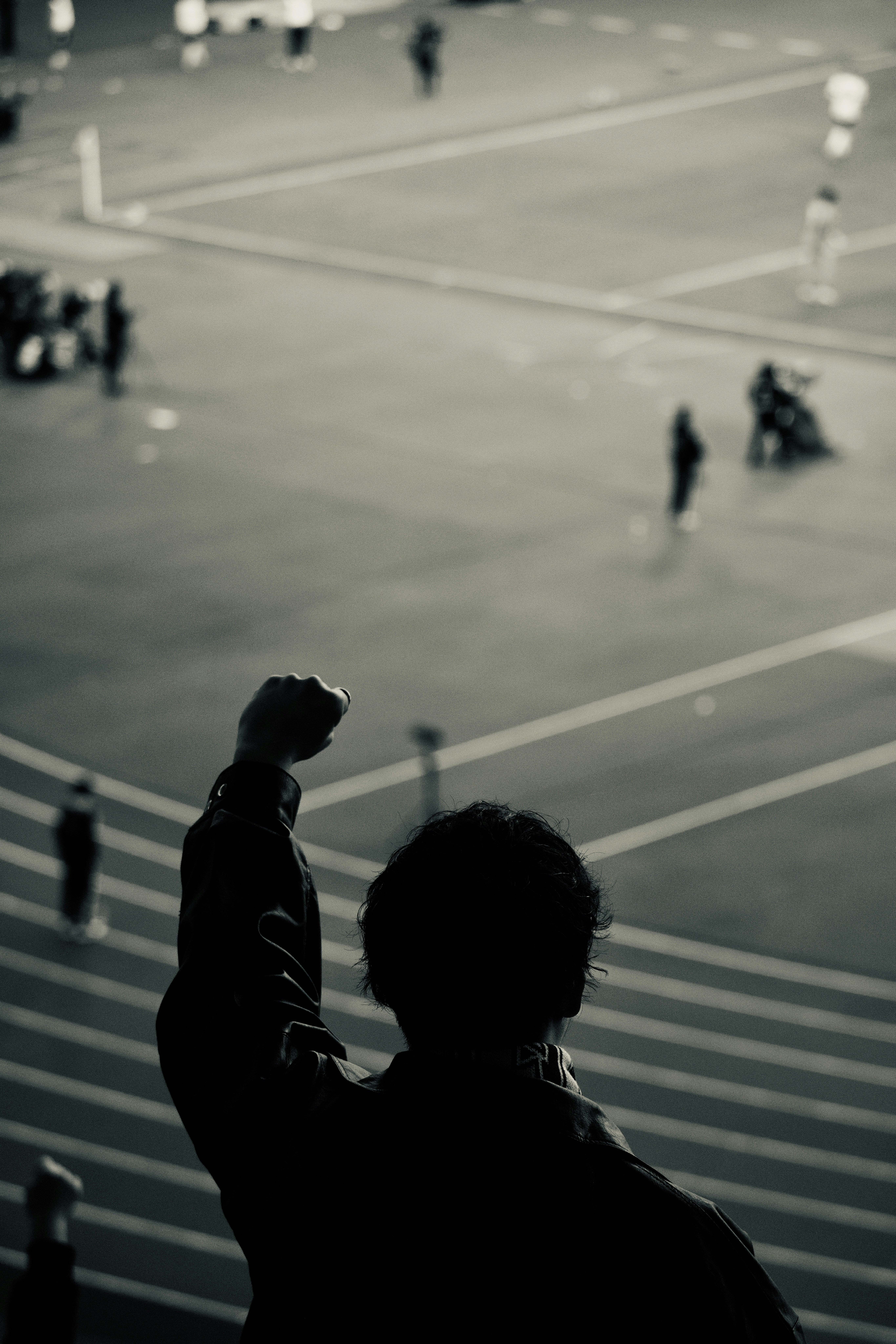 Person with raised fist watching a sporting event
