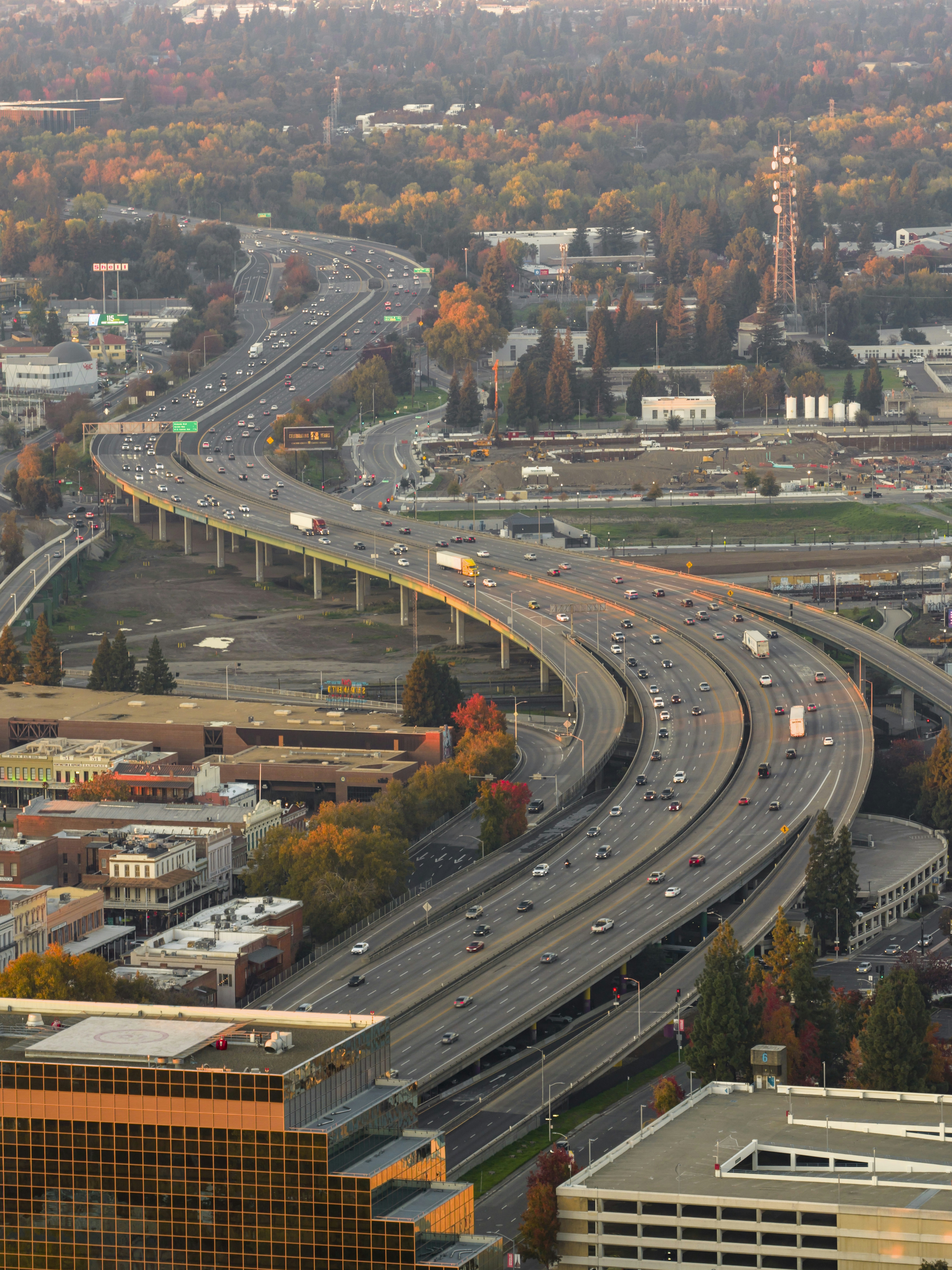 Busy highway interchange with traffic at sunset.