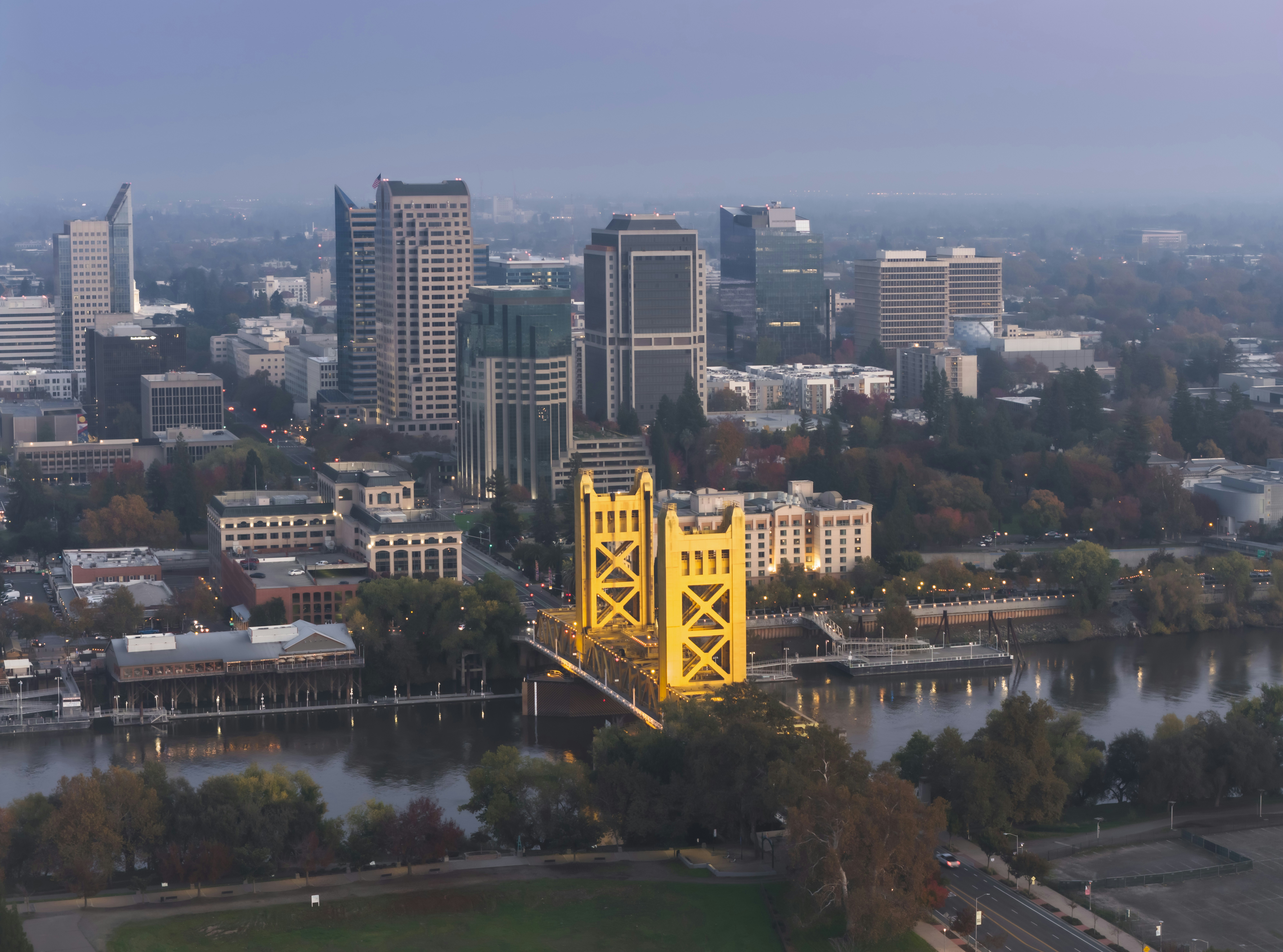 City skyline with illuminated bridge at dusk