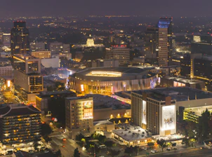 Vibrant cityscape with a stadium at night