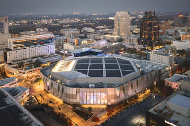 Modern arena in a city at dusk