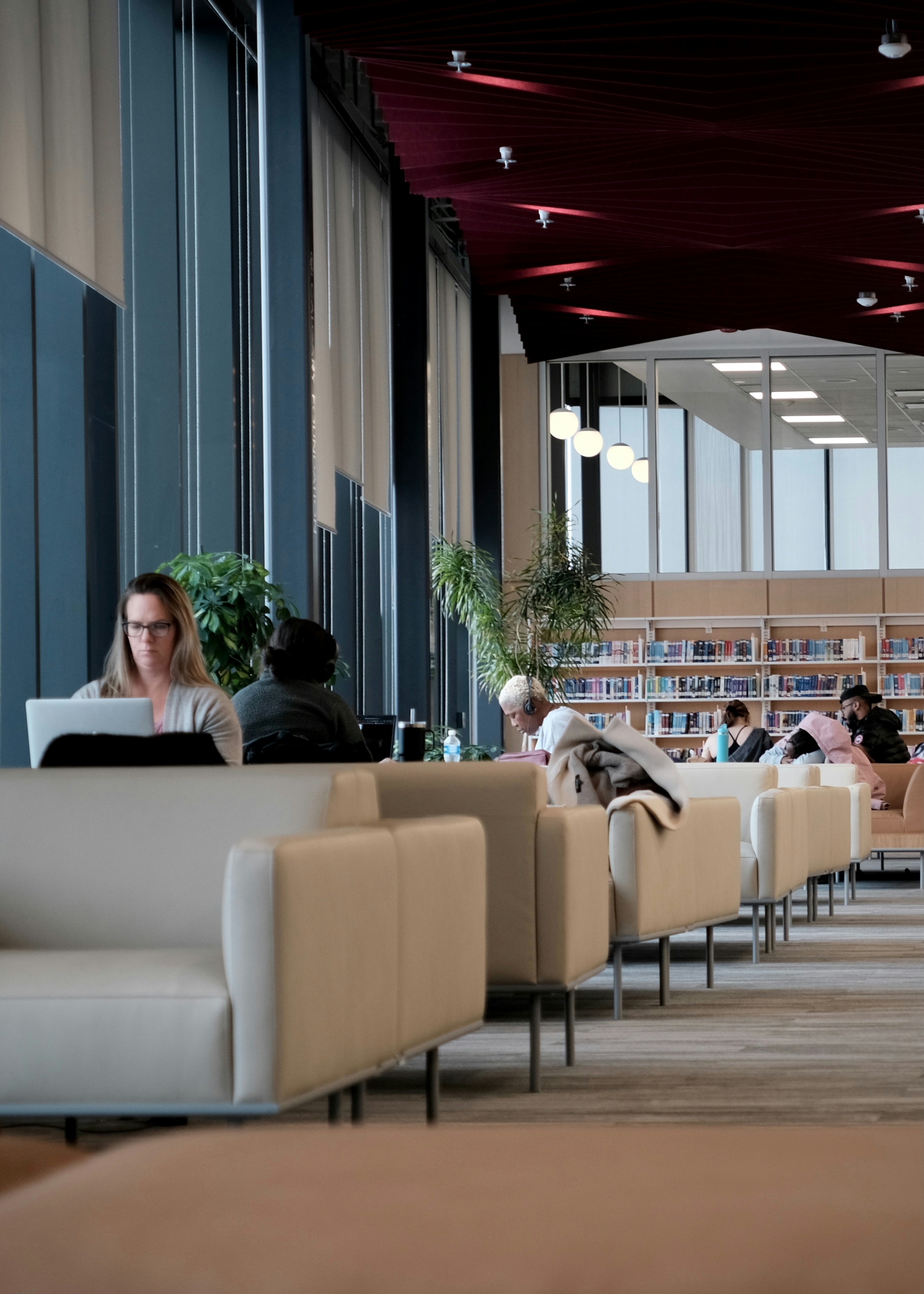 People working quietly on laptops in a calm public workspace