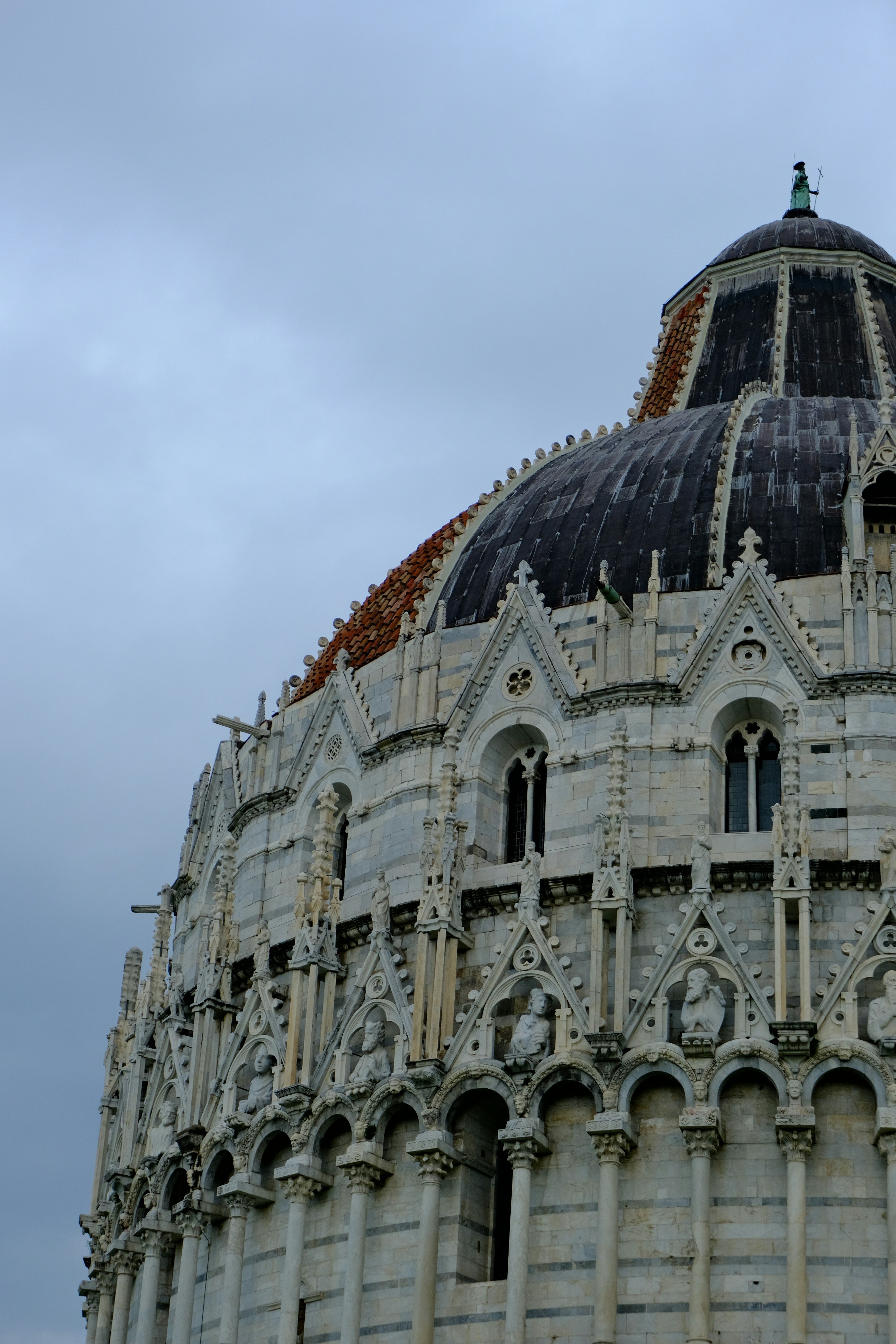 The baptistery of pisa under a cloudy sky