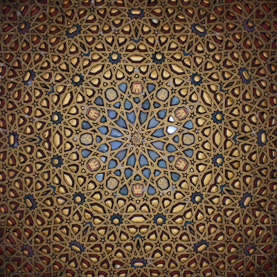 Intricate geometric pattern of a wooden ceiling