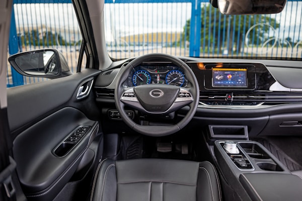 Interior view of a modern car dashboard and steering wheel.