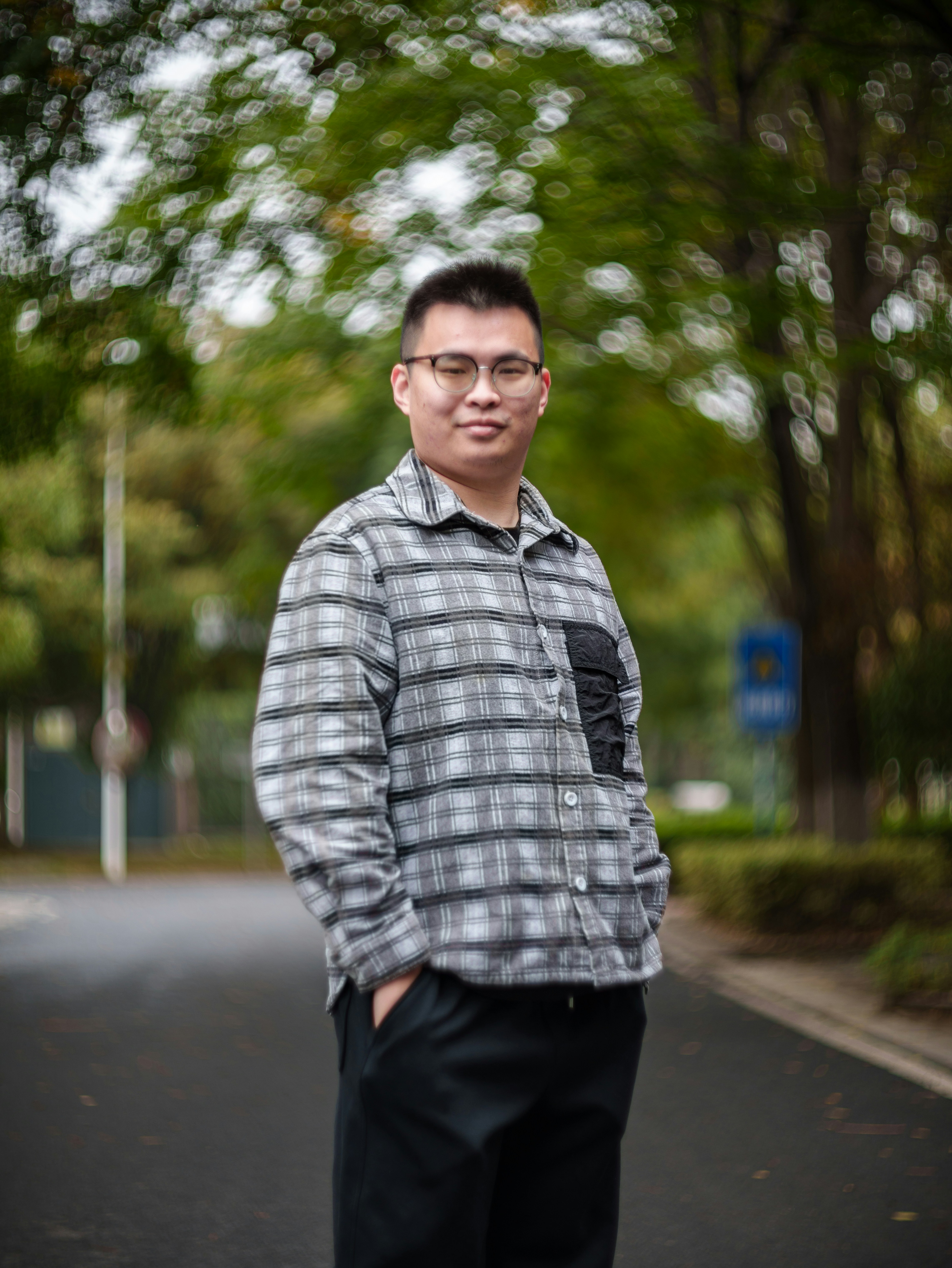 Man in plaid shirt standing on road