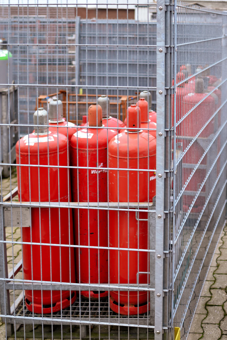 Propane cylinders stored securely in a locked safety cage