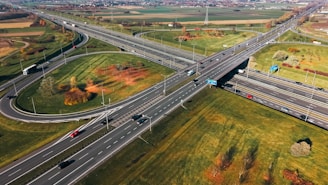 Aerial view of a highway interchange with cars.