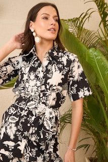 Woman in a black and white floral print shirt