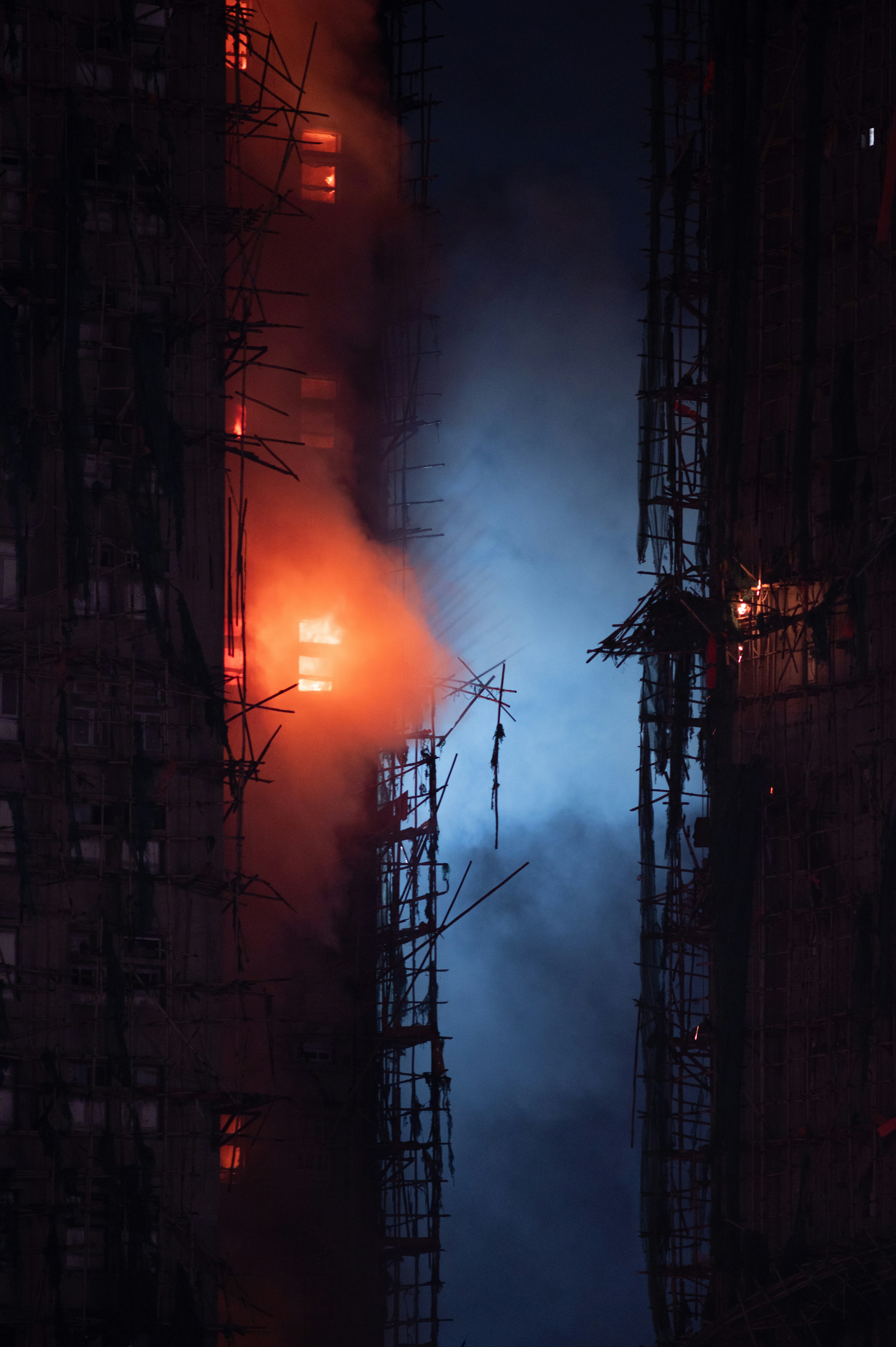 Building engulfed in flames with smoke billowing out.