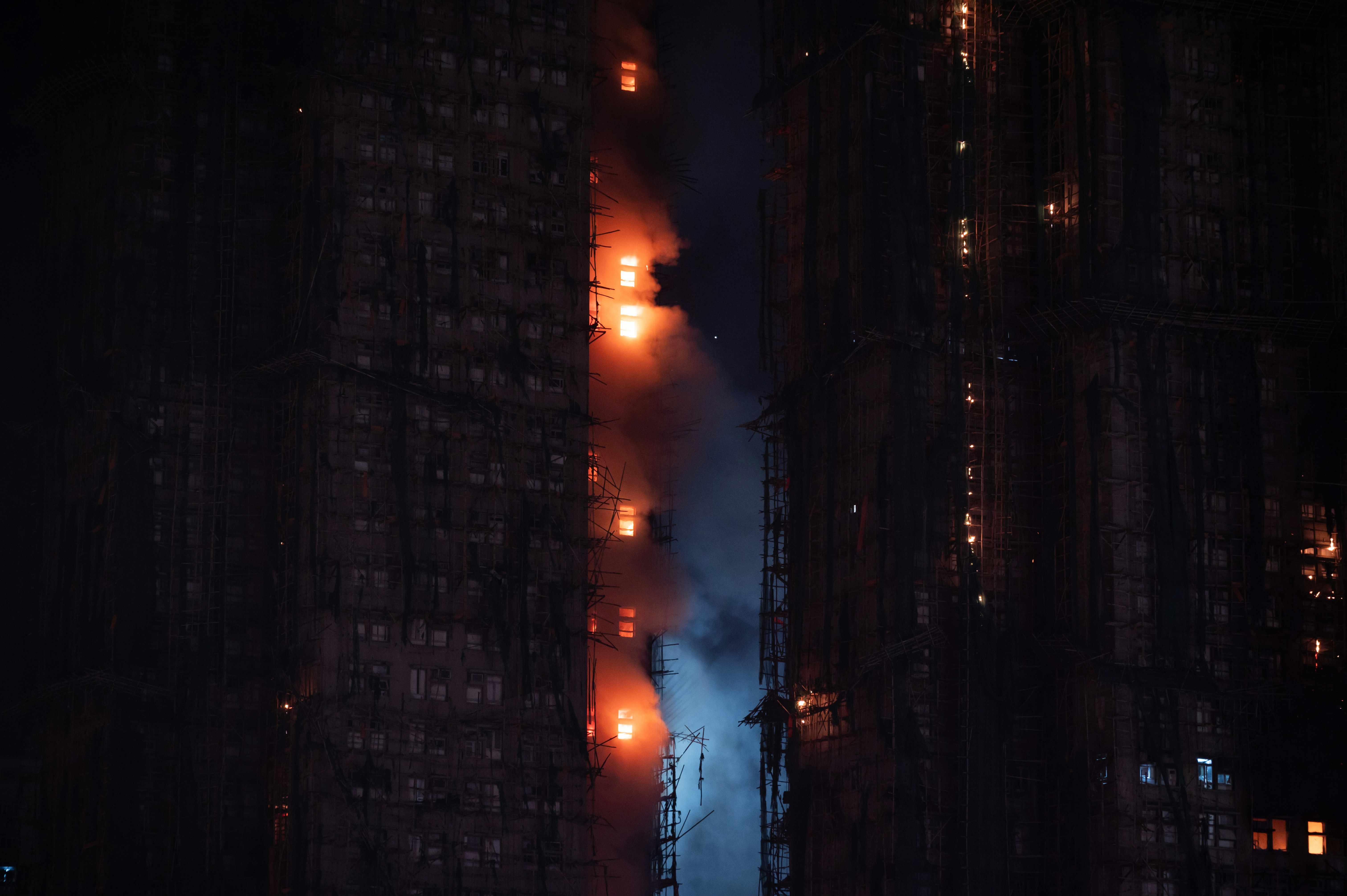 Apartment building engulfed in flames at night