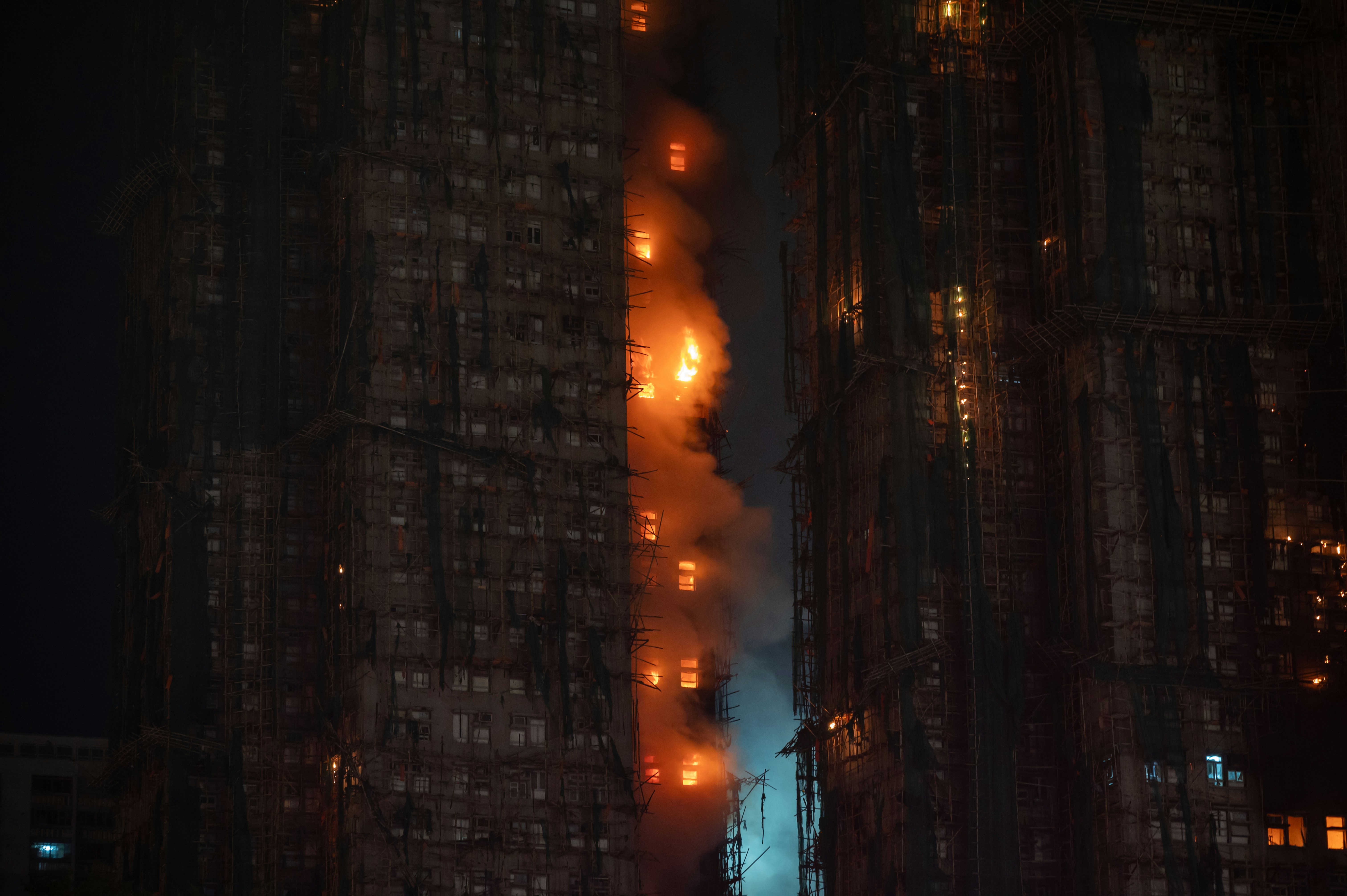 High-rise building engulfed in flames at night