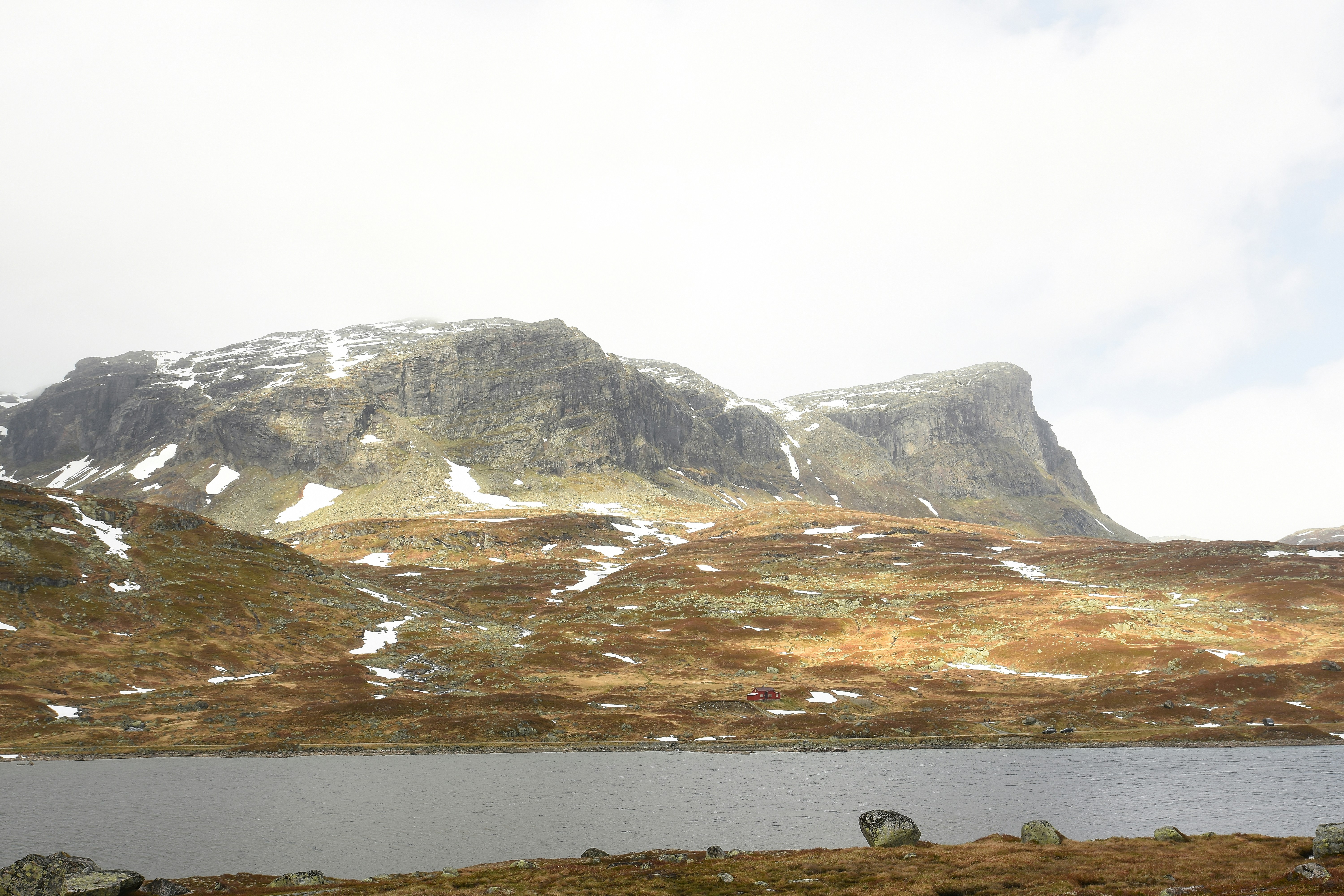 Snow-capped mountains rise above a serene lake