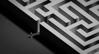 Small figure stands at the entrance of a large maze