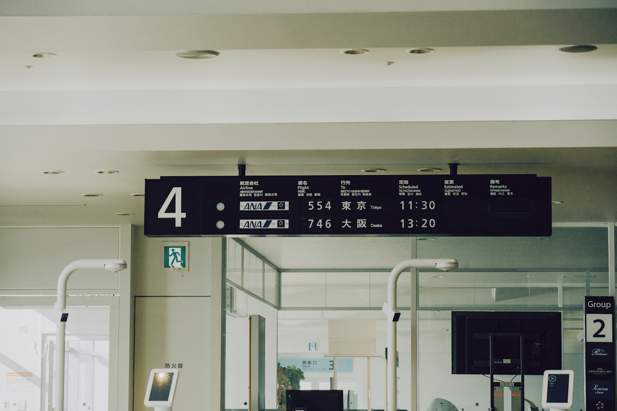 Airport departure board showing flight listings