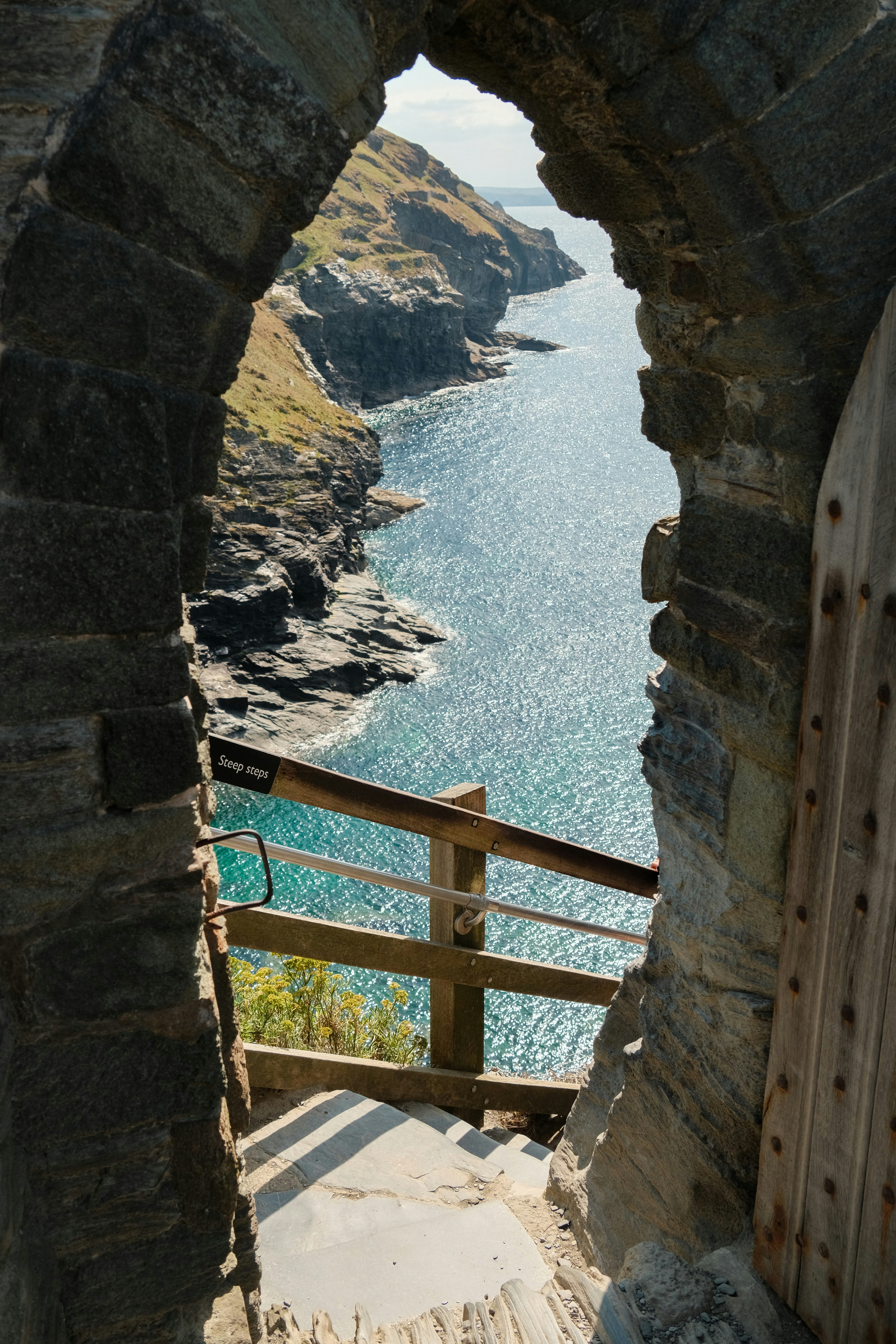 View of the ocean through a stone archway