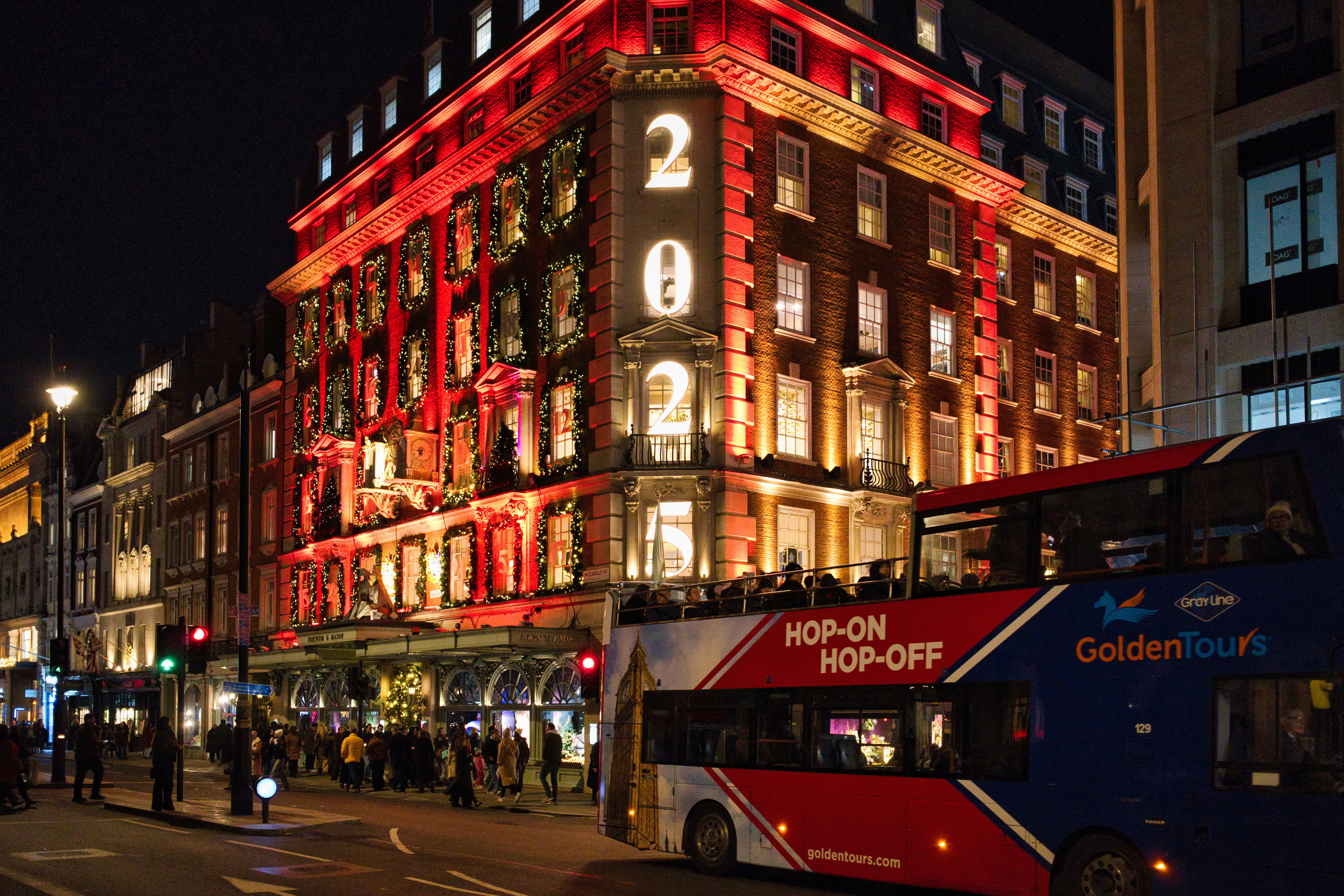 Ornate building illuminated with red lights at night
