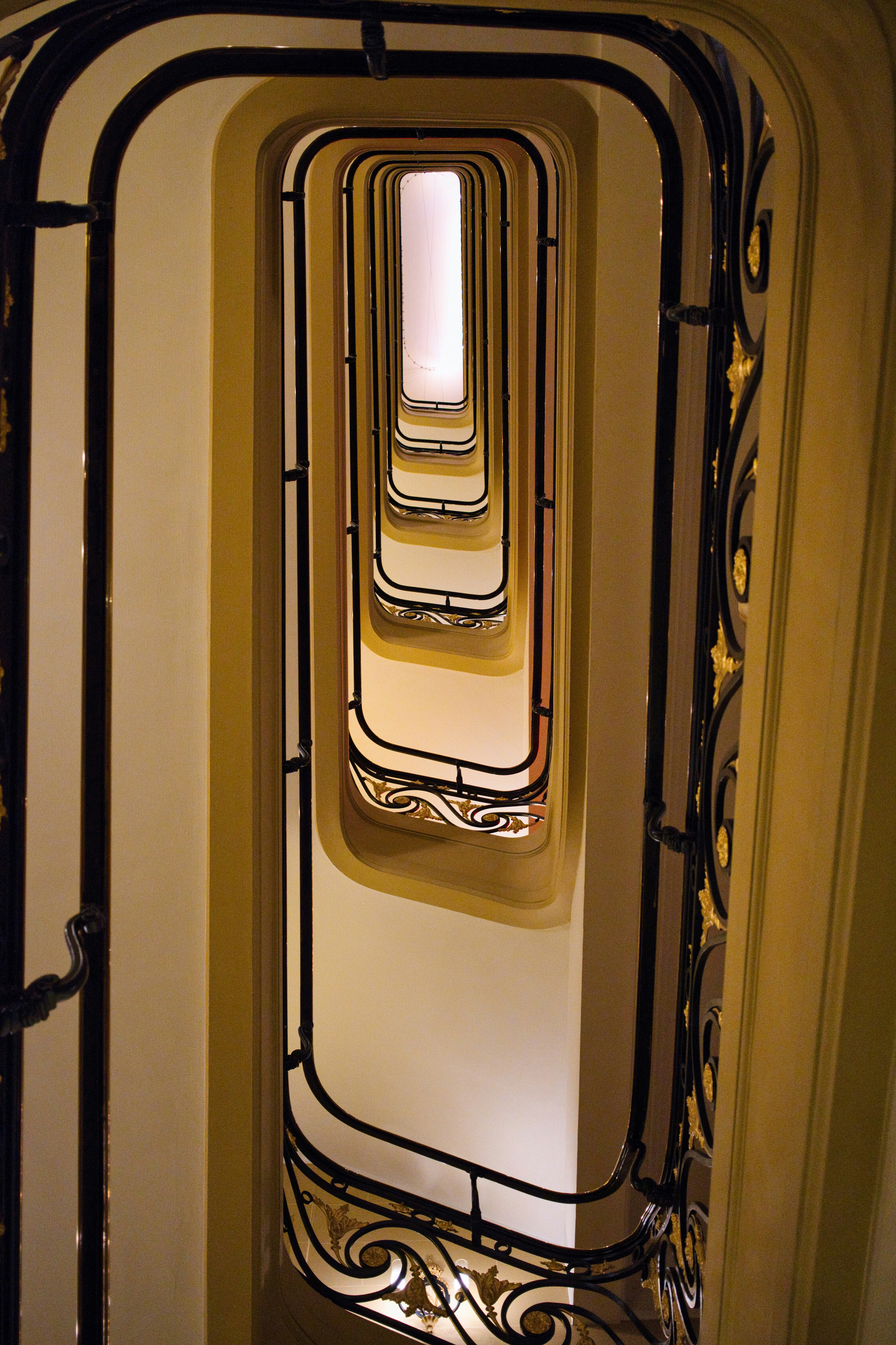 Looking down a spiral staircase with ornate railings