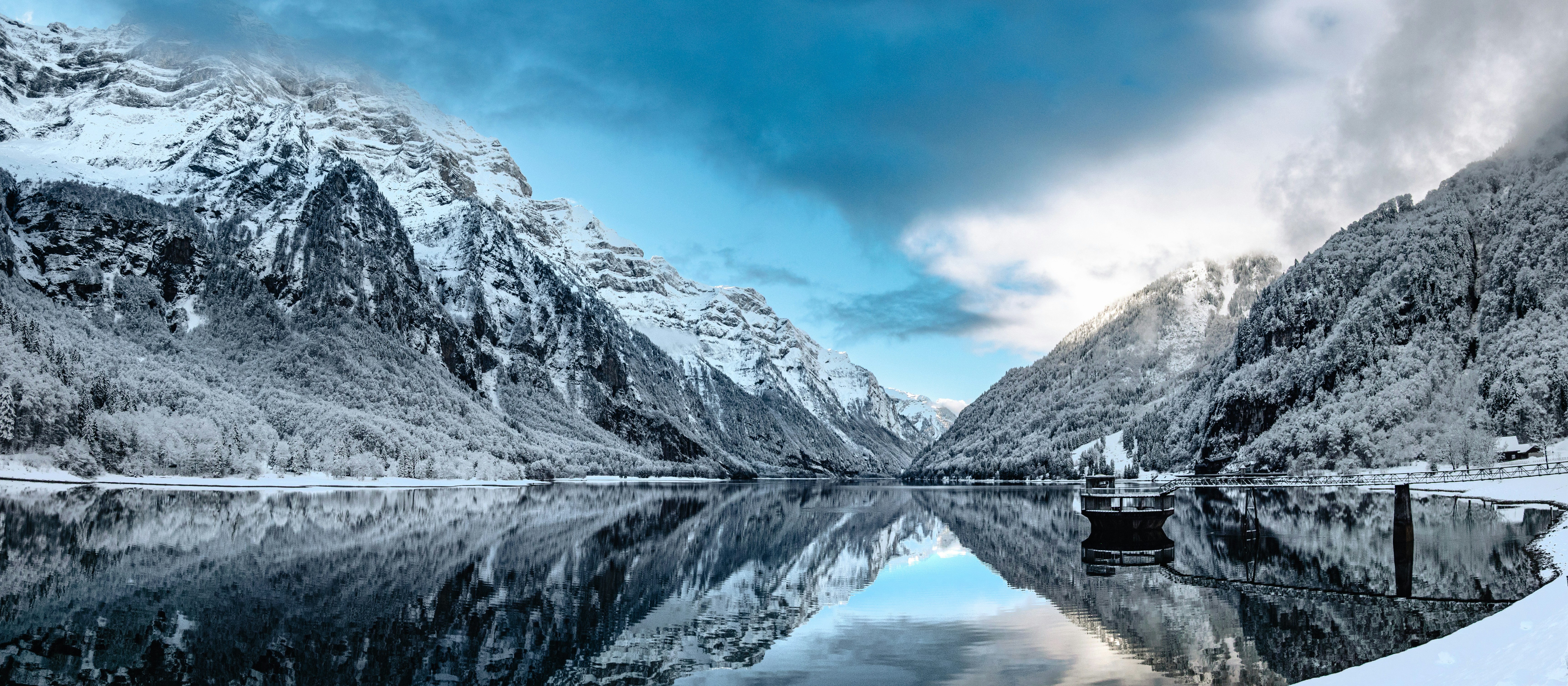 Snowy mountains reflected in a calm lake