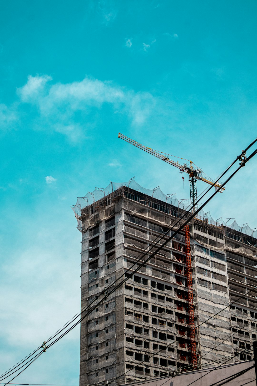 Construction crane over an unfinished building, like the half-built apps Builder.ai customers were left with
