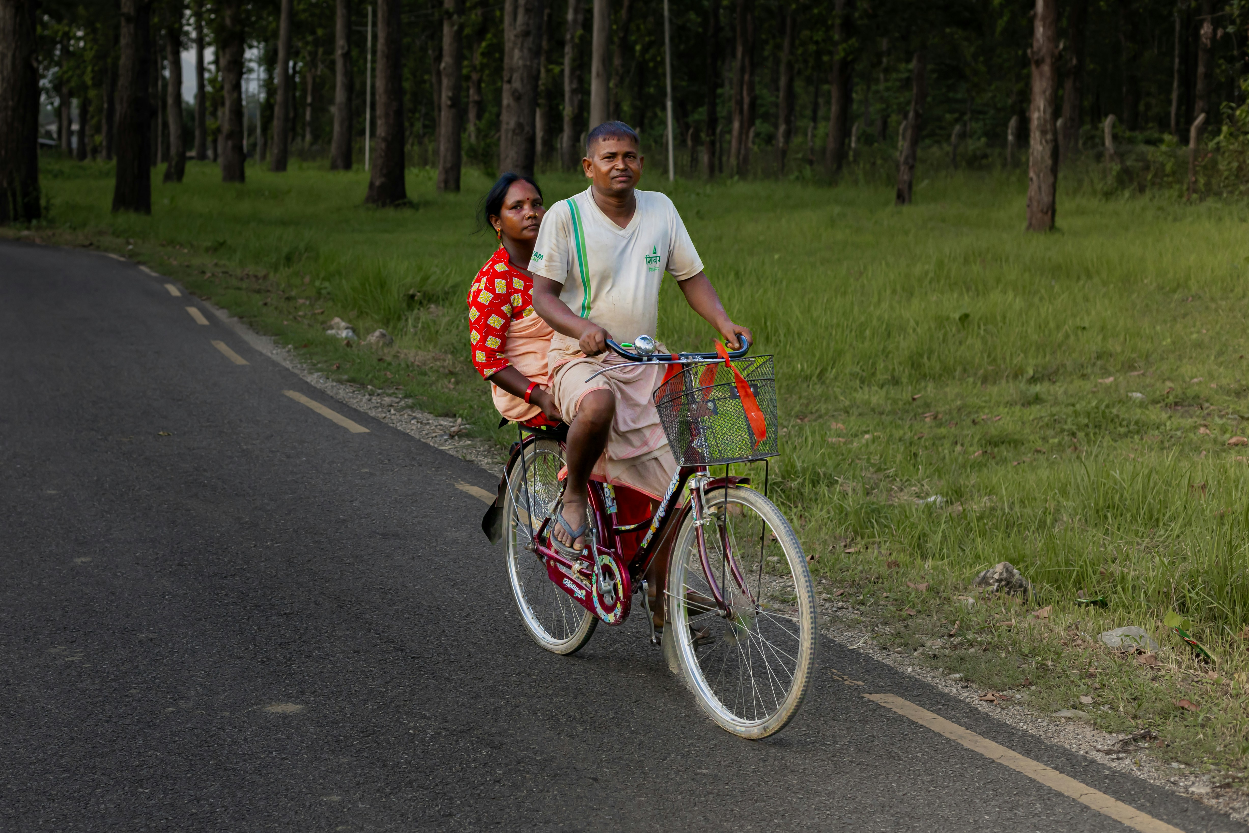 Couple riding a bicycle on a road