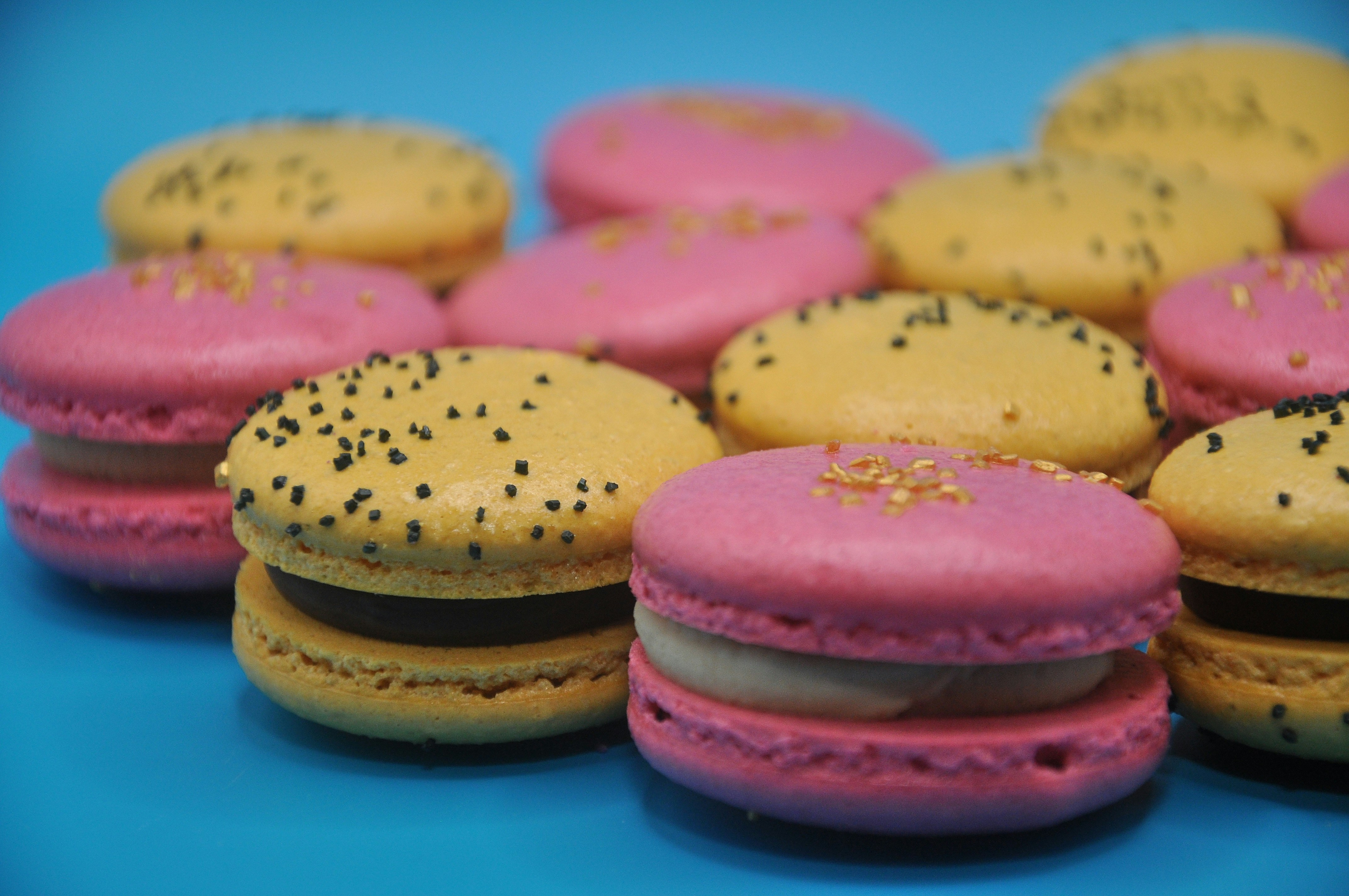 Pink and yellow macarons with cream filling.