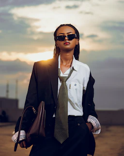Woman in suit and sunglasses at sunset